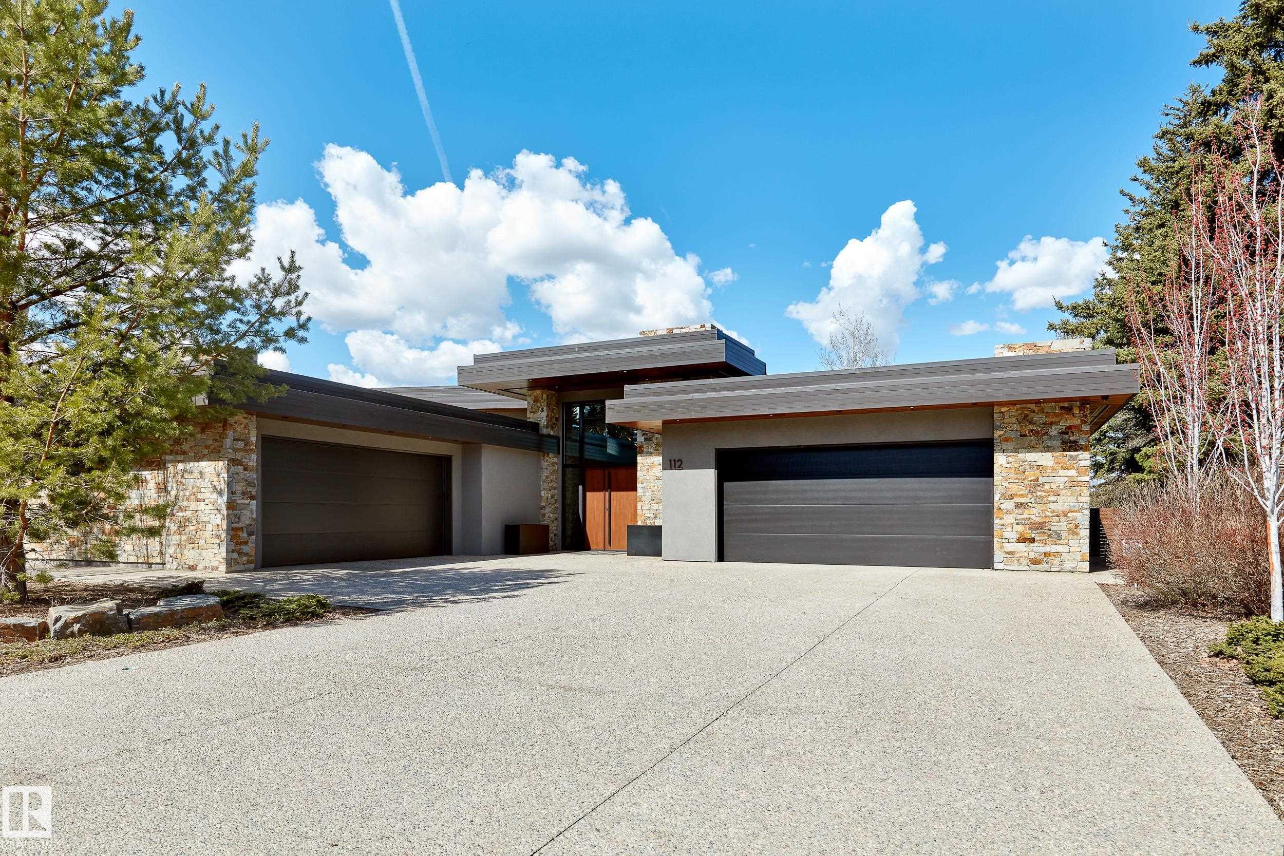 Panoramic RIVER VALLEY views ? backing onto Whitemud Creek Ravine ? full unobstructed view on this over 12,000sqft lot! The stunning home encompasses 5897 SQFT of developed living space with walkout basement ? luxury beds, Gym, Art Room, Office, 2.5 baths, 15ft ceilings ? North & South Garages - Quad attached garage (extra height for car lifts) ? the entire back of the home is floor to ceiling windows.The attention to detail provides the perfect fusion between structural strength & architectural form ? Urbis Architecture, Mitchell Freedland Design/Vancouver! This home seamlessly blends indoor/outdoor spaces capturing all elements of luxury ? Flawless design covers every inch of this stunning home well-appointed & sophistication throughout. Every finish was hand selected for a luxurious feel - custom millwork & cabinetry, superior lighting & plumbing fixtures - the craftsmanship is like no other fit & finish you have never seen before ? West Coast Luxury in YEG - boasting every state-of-the-art finish.