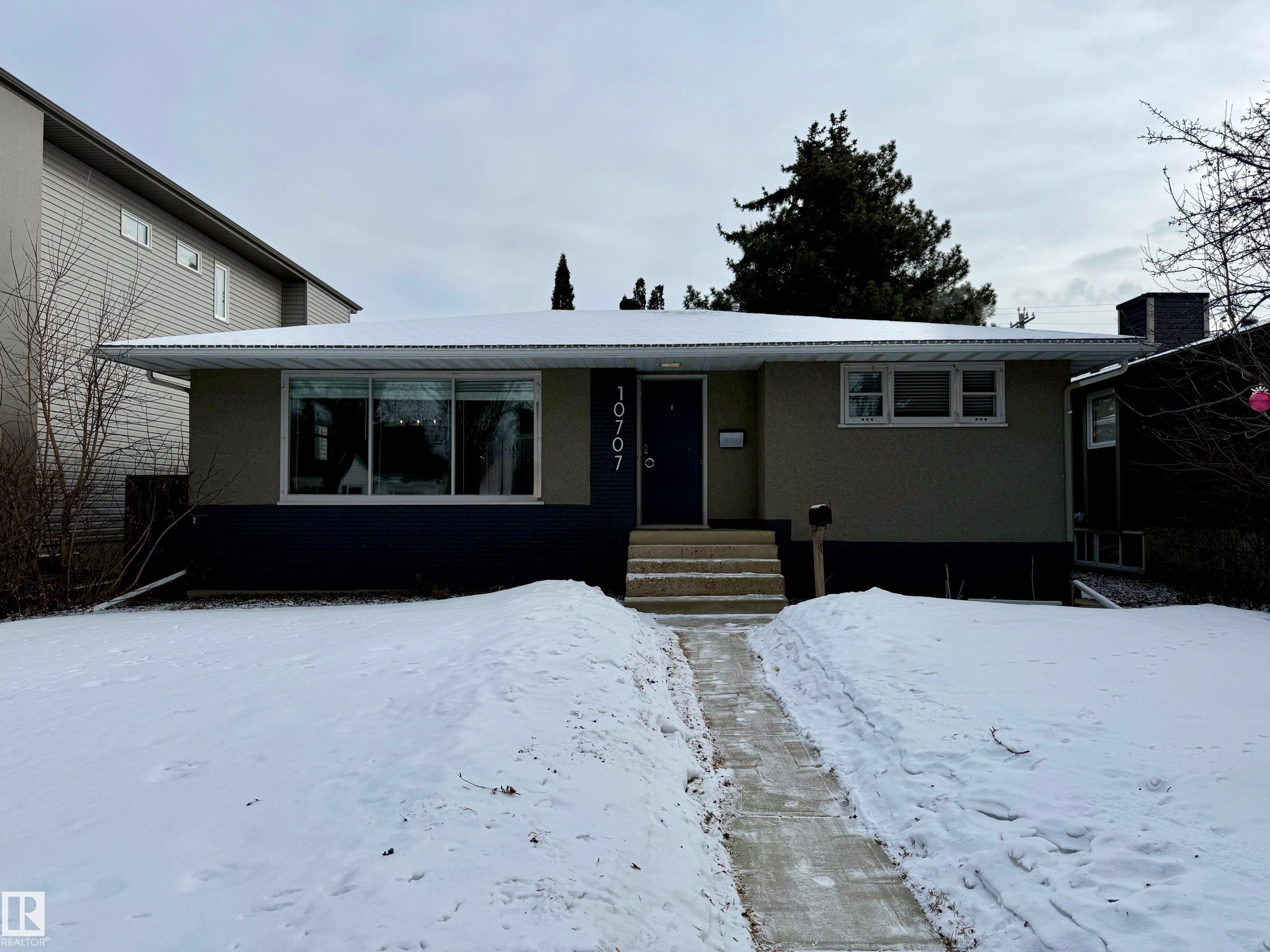 Westmount Bungalow ? Timeless Mid-century Charm Step into classic bungalow in highly sought-after Westmount. This lovingly maintained 1954 home sits on a generous 50 x 140ft lot�on a quiet, treelined street?walkable to parks, caf�s, schools, and the vibrant local shops that make Westmount one of the city?s most desirable communities.  Updates: New roof (2012); new laminate flooring (2017); fully renovated bathrooms (2017). Condition: Well maintained, move in ready with tasteful updates that respect original character. Zoning: Medium Scale Residential RMh16 ? attractive for infill or redevelopment opportunities subject to city guidelines. This home offers a rare combination of classic mid-century character, recent modern updates, and an exceptional Westmount location?ideal for homeowners who value neighbourhood lifestyle or investors seeking strong redevelopment potential.