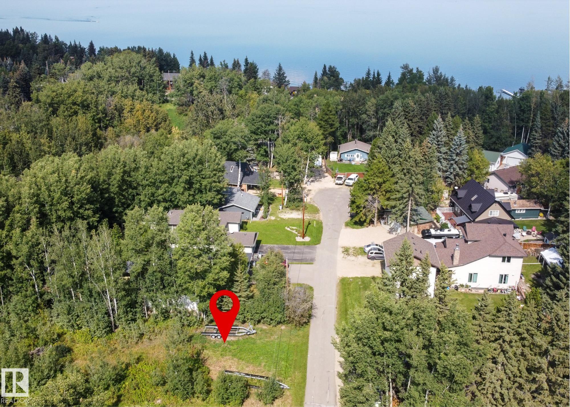 Build your dream home or lake getaway on this beautifully treed lot backing onto a peaceful ravine. Enjoy privacy, natural surroundings, and the flexibility of a walk-out design in a truly sought-after location. Services are conveniently located at the property line, making development simple and straightforward. Whether you?re envisioning a cozy cabin or a custom family home, this lot offers endless potential. Located within walking distance to the charming Village of Pigeon Lake, you?ll love easy access to shops, dining, and everyday amenities. The lake is just a short stroll away, offering year-round recreation and lake-life enjoyment. A rare opportunity to create your ideal retreat in a quiet, scenic setting close to it all.