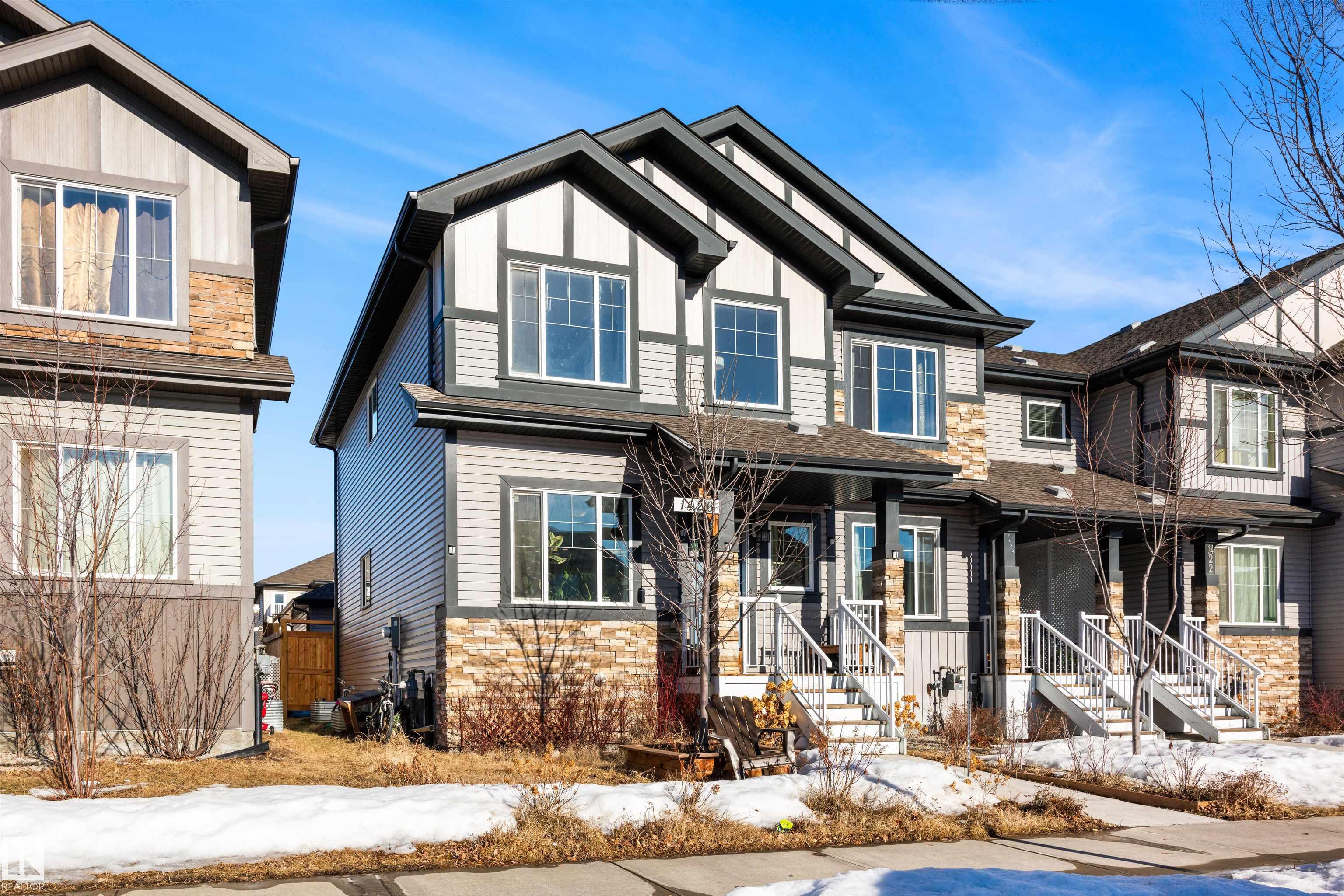 Welcome to this stunning end-unit Sterling Homes 2-storey in the heart of Tamarack, one of Southeast Edmonton’s most walkable communities with no condo fees. Offering 1,435sqft, 4 bedrooms, and 3.5 bathrooms, this home features a bright open-concept main floor with 9 ft ceilings and large windows, a kitchen finished with quartz countertops, tiled backsplash, pantry, and an oversized island with eating bar flowing into the dining area, plus a convenient main floor half bath and laundry. Upstairs includes three generous bedrooms, including a king-sized primary suite with a walk-in closet and a 4-piece ensuite, along with an additional full bathroom. The basement adds a spacious family room, fourth bedroom, and 3-piece bathroom, while the fenced yard with deck and double detached garage completes the package. Located steps from schools, the Meadows Recreation Centre, library, parks, shopping, and transit, with quick access to major routes, this home offers exceptional convenience and an unbeatable lifestyle.