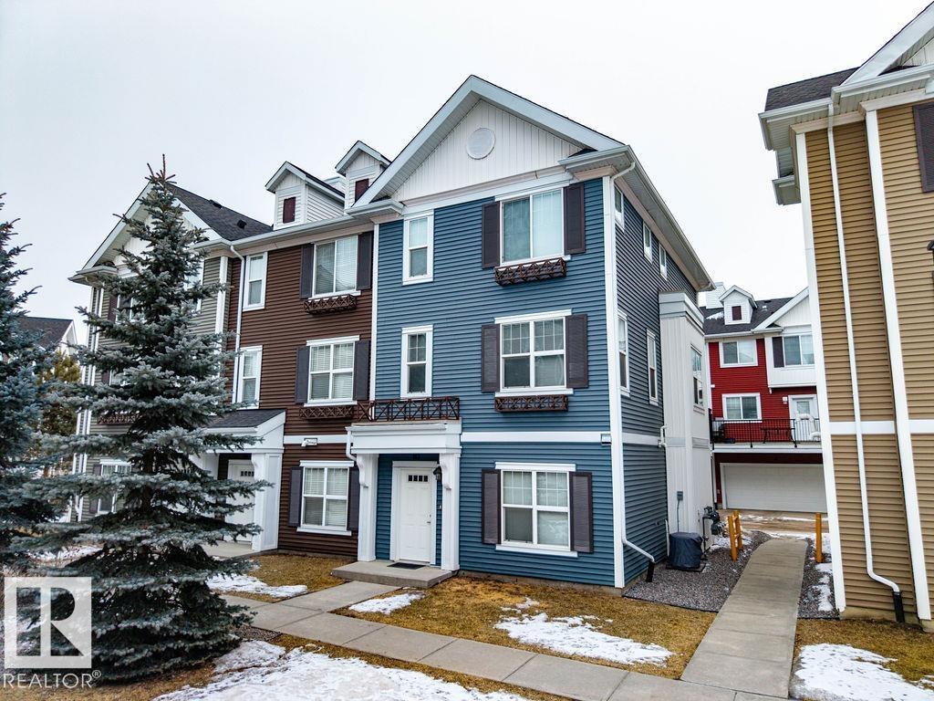 Welcome to this beautifully designed 3-storey, *end unit* townhome offering the perfect blend of space, functionality, and convenience ? all with low condo fees! The main level features a bright and inviting living room *overlooking a central green space*, a well-appointed kitchen with ample cabinetry and workspace, a convenient 2-piece bath, and direct access to a private patio ? perfect for morning coffee or summer BBQs. Upstairs, you?ll find three spacious bedrooms, including a comfortable primary suite complete with ensuite, a full main bathroom, and the added convenience of upper-floor laundry. The entry level allows bonus space for a den or fitness area while the double attached garage provides secure parking and additional storage space, a rare and valuable feature in townhome living. Close to shopping, dining and public transit; this home is a total gem!