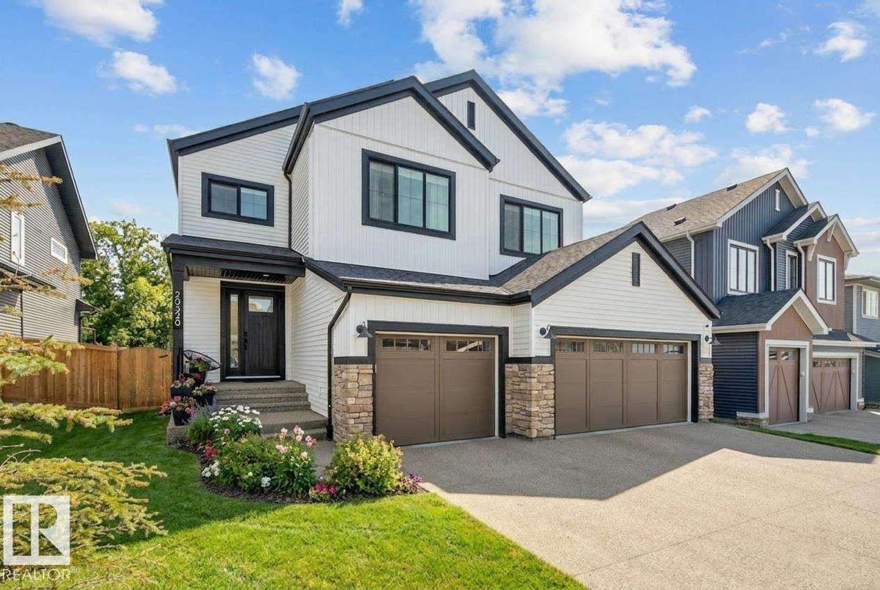 This elegant custom built home blends timeless architecture with refined, minimalist design. Perfectly positioned along an extensive walking trail & forested green space offers both privacy & a serene natural backdrop. All details curated for comfort & family living. Stunning, spacious kitchen showcases a luxury leather-touch Cambria Quartz Island, gas range & hidden butler?s pantry with direct access to the garage. The open-concept main floor is graced by an open stairwell leading to the upper loft, creating a sense of light & architectural interest.  Upgrades include Hardwood Flooring, Oversized Windows, Custom floor-to-ceiling Drapes, main-floor office & large upper laundry room. With 4 bdrms, 3.5 baths, A/C &Triple garage. This Home is perfect for all family sizes. The Fully finished basement has a stylish wet bar, recreation room, an extra bedroom & a 3-piece bathroom?perfect for guests & entertaining. Walking distance to park, playground & transit, this home blends luxury, comfort, and convenience.