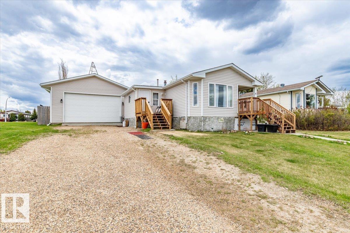 This property has a 1079.63 sq/ft home and a huge 25' x 28' fully finished garage. Enter the home through the front porch that is not included in the RMS measured square footage. The kitchen and living room are an open concept with the dining area as well. Down the hall is the laundry room, 4 piece bathroom, and 3 bedrooms. The fully finished garage has 12' high ceilings, power, heat, a cement floor, and a 18' wide by 10' tall overhead door. The back yard is fenced completing the property. Shingles were replaced in November 2025. New front Deck with stairs also done in 2025.