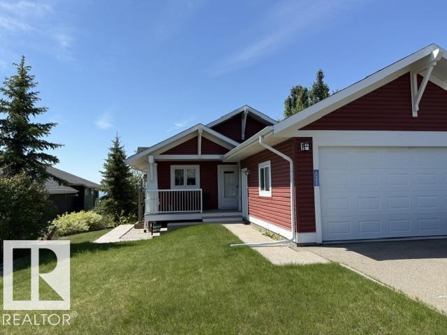 Welcome to the prestigious Estates At Waters Edge!  This immaculate 1227 sf WALK OUT BUNGALOW is move in ready!  The main floor features a sunny kitchen, dining and Livingroom with a view of Lac Ste. Anne with a large balcony.  The kitchen has granite counter tops and plenty of cabinet and counter space!  The primary bedroom is spacious with a walk in closet that could be converted into an ensuite!  The second bedroom is large enough to have more than one bed in it.  The lower walk out level has 2 generous size bedrooms, another 4 pc bathroom with a large recreation/family room with a pool table.  This home is located in a secure gated community 45 minutes NW of Edmonton.  Some of the features of this neighborhood include a heated outdoor pool, clubhouse, gym, playground, beachfront park and more!  2000+ sf of professionally finished space!