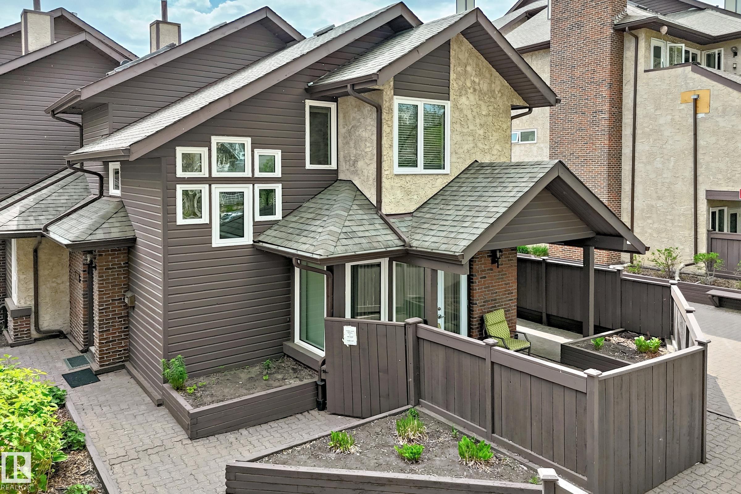 Walk to University & River Valley trails!! LOCATION+++ This ORIGINAL owner townhouse has been extremely well cared for and UPGRADED. Evident pride of ownership!  Complex has newer windows and shingles replaced approx. 2012.  Main floor features upgraded kitchen (with breakfast nook), American Cherrywood hardwood floors, large formal dining room, living room with gas fireplace and access to your private patio (natural gas BBQ outlet) and garden area.  Main level also has a spacious den + 2 piece bath.  Upper level has large primary bedroom with direct access to full bathroom + 2nd bedroom.  Lower level rec room (all furniture can be included -- hide-a bed; shelving unit; TV + Stand; computer/desk/chair). plus 3 piece bath.  Mechanical room (freezer + water softener inc.) with direct access to parkade and THREE TITLED parking stalls.  Extra private ATTIC STORAGE SPACE with access through primary bedroom.
