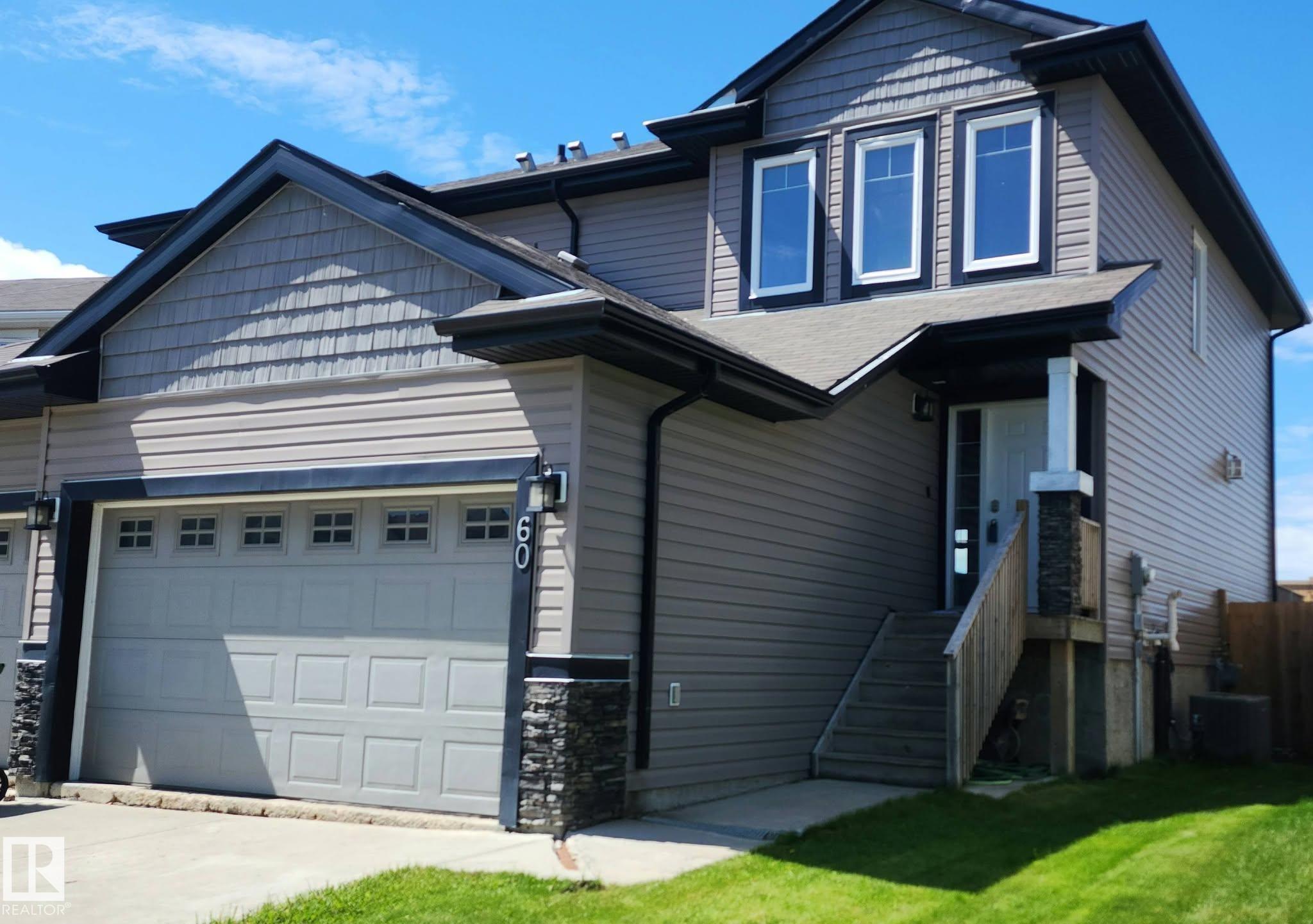 Great starter investment in a family oriented neighborhood. Start out with a half duplex that offers 2 primary rooms with ensuites. with a double attached garage. When you first step inside you will enjoy the large entry way. An excellent place to put that entry table. Enter into the kitchen that is open to the living room and dining area. The kitchen has a brand new gas stove. If you are a person who loves to cook this kitchen with its walk in pantry is for you. On cool nights turn on the fireplace and cozy up with a book. The patio doors take you out to the deck to have your refreshing morning coffee.  As you head upstairs you will notice the large laundry room . The best part are the 2 primary bedrooms with their very own ensuite. The basement is not developed but a bedroom could easily be put down there with a work out room or a family room. Enjoy a fenced yard. And last but not least there is a double car attached garage with direct entry into the house. Great neighborhood with walking paths.