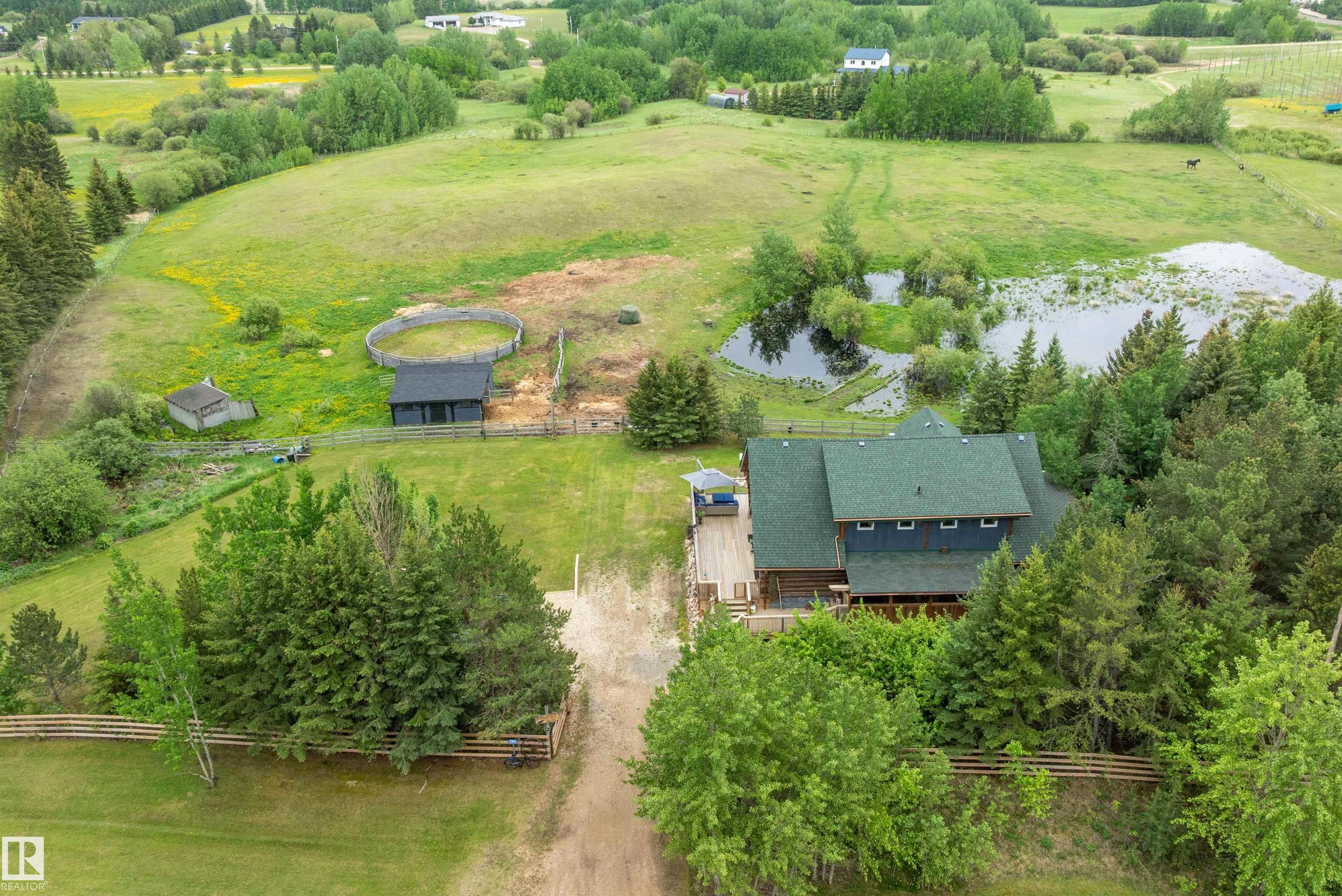 AMAZING UPDATED & UPGRADED, 2058 sq. ft. WALK OUT 2 STOREY LOG HOME on 6.94 GORGEOUS ROLLING & TREED ACRES, FENCED for HORSES with a 2 STALL BARN, TACKROOM, ROUND PEN & WATERER, & it is on the BEAUMONT SCHOOL SYSTEM! WOW! Bring your HORSES HOME & enjoy the STUNNING SOUTH VIEWS & the PRIVACY that this RARE PROPERTY OFFERS! GREAT ROOM style with freestanding central GAS STOVE, upgrades include SHINGLES, FURNACE, HWT, a 3800 CONCRETE CISTERN, FRESH BATHROOMS, NEW TIMELESS KITCHEN with FARM SINK, STAINLESS APPLIANCES including an INDUCTION STOVE, PULL OUTS, HUGE ISLAND & QUARTZ COUNTERS, CUSTOM LIGHTING & FANS, FABULOUS WRAP VERANDAH. The SPACIOUS MAIN FLOOR PRIMARY has access to the 3 pc.bath & PATIO DOORS to the DECK/SCREENED PORCH. Up to a SUNLIT BEDROOM, an UPDATED 4 pc. bath plus LOFT/STUDIO overlooing the main floor. The WALKOUT features a LARGE FAMILYROOM, BEDROOM & UPDATED 3 PC. BATH, GYM/DEN, storage, LAUNDRY & PATIO DOORS out to the YARD! Rock beds, LVP, EURO EAVESTROUGHS & DOWNSPOUTS, GATED & MORE!
