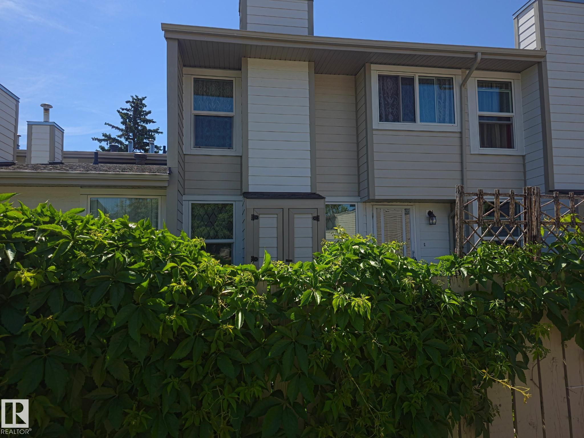 Discover this impeccably maintained three-bedroom townhome situated in the highly convenient community of Ekota, showcasing evident pride of ownership. This residence offers a warm, inviting layout perfect for comfortable daily living, highlighted by a beautifully updated kitchen featuring rich chocolate cabinetry, ceramic tile flooring, a contemporary backsplash, and quality stainless steel appliances. The spacious living room provides ample natural light from its large window overlooking the yard and is centered around a charming wood-burning fireplace. Upstairs, find three generously sized bedrooms and a well-appointed, spa-inspired four-piece bathroom. This professionally managed complex has a fabulous location surrounded by parks and mature trees, making it an excellent opportunity for both homeowners and investors, further enhanced by recent significant exterior upgrades including new hardyboard siding, windows, and roof.