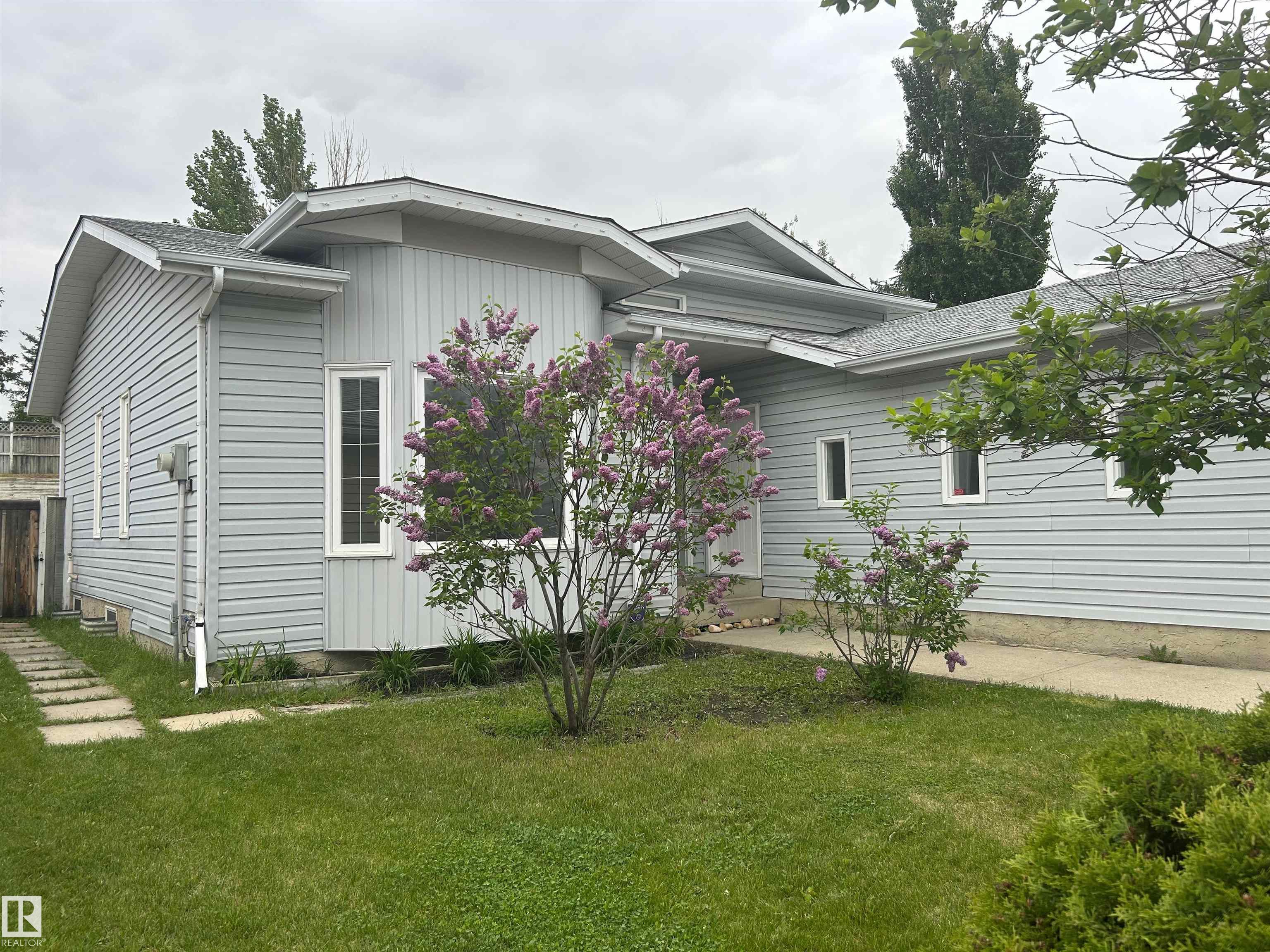 Welcome to this renovated and completely re-painted 4 level split in Lymburn conveniently located to a variety of amenities, schools, shopping, Callingwood Farmers Market, West Edmonton Mall, the new LRT line, Jamie Platz Family YMCA. All newer stainless-steel kitchen appliances, brand new 40? high white kitchen cabinetry, quartz counter tops, dbl undermount sink, mobile kitchen island, brand-new asphalt shingles, high efficiency furnace, 50 US gallon hot water tank and triple pane vinyl windows throughout the home. Main and upper level have brand-new laminate flooring, the bathrooms are fitted with brand-new vanities and sinks, freestanding gas burning fireplace in the family room, newer front-loading washer and dryer, North-East facing back yard deck measuring 4.42x3.63. This home has 4 generous bedrooms, 3 multi-piece bathrooms, living room, dining room, family room and partially finished basement ready for further development and a two car attached garage with additional parking for 2 more vehicles.