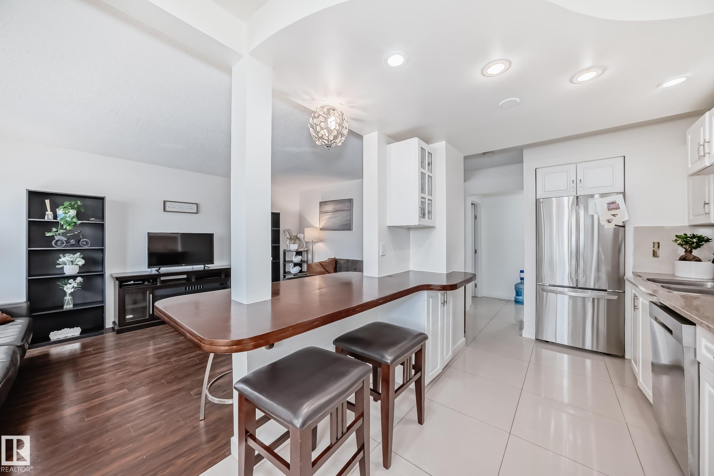 Absolutely stunning unit self-managed Amberly Court complex. Amazing renovations include granite kitchen countertop and eating bar, newer kitchen cabinets, beautifully tiled floor, fresh coat of paint throughout, newer furnace, and a newer hot water tank. Living space on the main floor can be used as half dining and half living room, or just use the eating bar and enjoy one large living room! Upstairs has 3 bedrooms and a full bathroom with tub and shower. The fulling finished basement gives plenty of space for a family room, complete with an extra bathroom, storage, and utility room. Fenced back yard requires very little maintenance but gives plenty of enjoyment. Great for young adults or a new family. Plenty of amenities nearby, including Costco, Superstore, shopping and schools! You can see the pride of ownership in this one, 10 out of 10! Amazing value and a must see. Did I mention low condo fees? Come have a look!