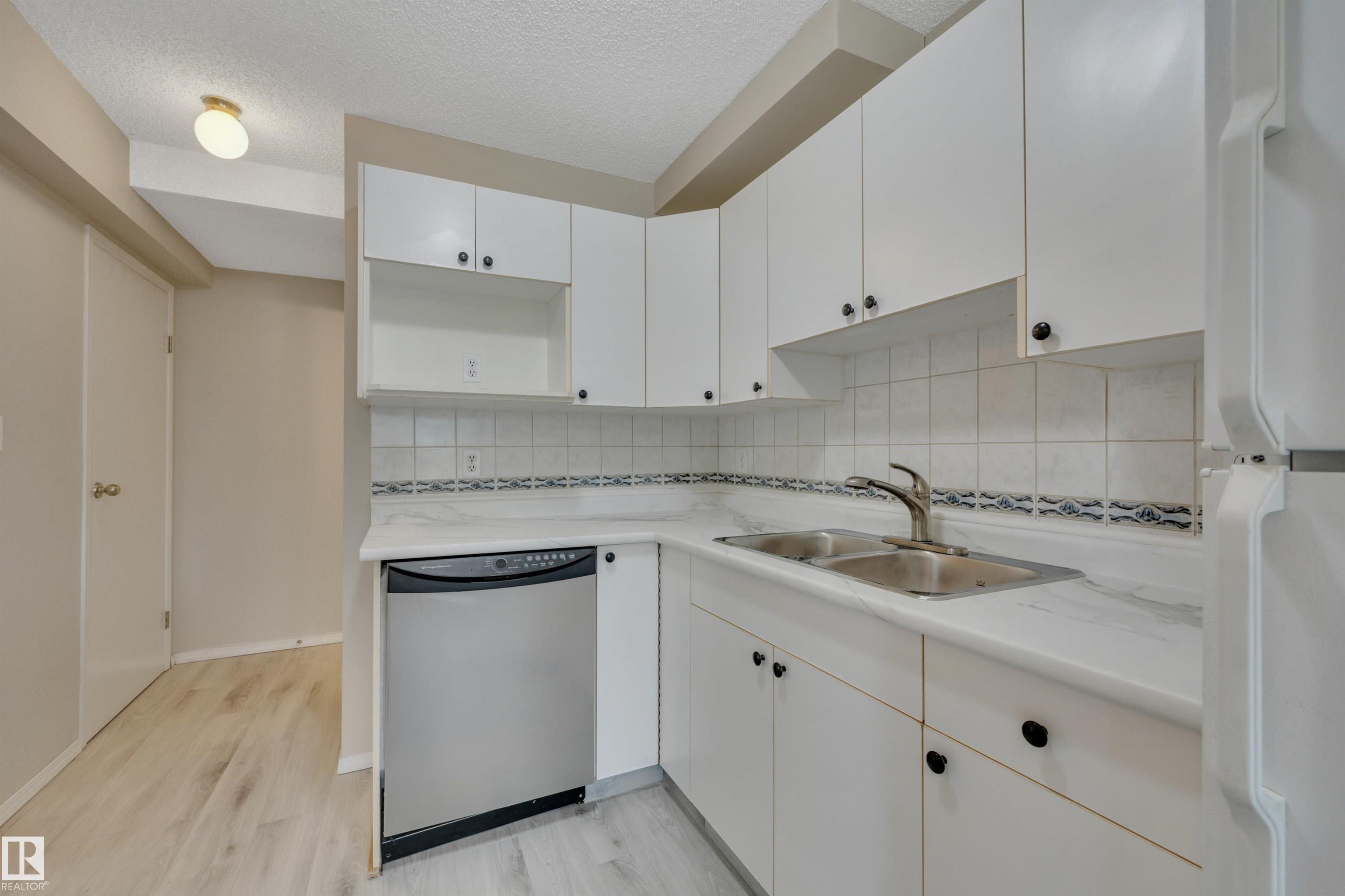 Ready and waiting for you! Welcome to Daly Grove, this well cared for 8 unit condo complex is one of a kind. Located close to Shopping, Schools transit and major bus routes.  This 2 story condo shows great, nice and clean. Living room w/Laminate flooring has sliding doors to small fenced yard. Brand new Luxury Vinyl flooring in the Kitchen, Dinette and in the  2 bathrooms. Kitchen has new countertops! Dinette has large window overlooking the West Yard.  Up the stairs: Laminate flooring throughout the upper level. Primary bedroom has large walk-in closet. 2nd bedroom and 4 pce bath complete this upper level.  Basement is full and open with Laundry room and utility room. Energized Parking stall just a few steps away from your main door. Condo fees are $240.00 Monthly. Taxes are $2260.00 Yearly.  Self Managed Condo: Includes lawn & snow removal, exterior maintenance,  reserve fund, Insurance for the exterior