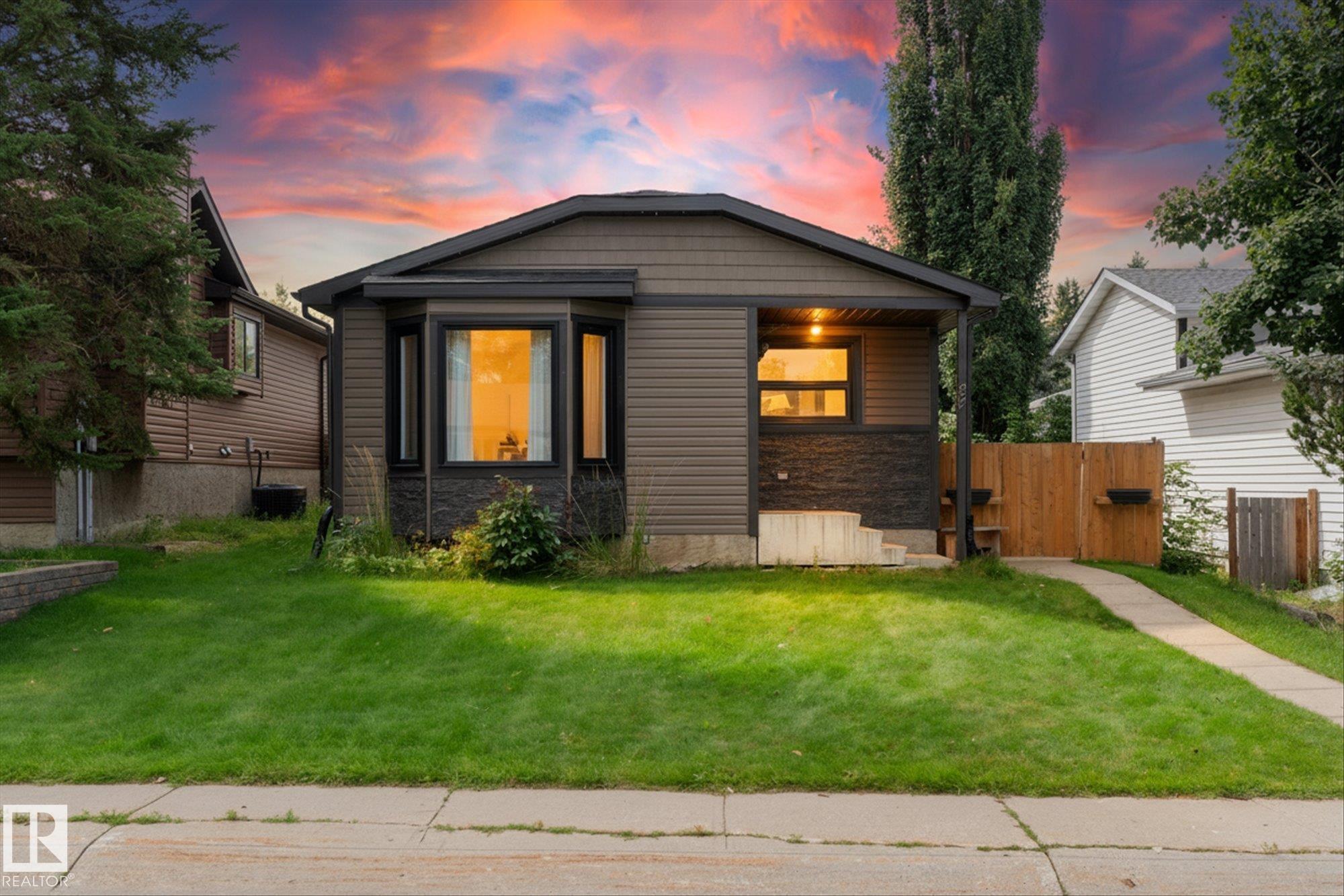 Backing directly onto McKeen Park, this updated 4-level split in Spruce Grove's Millgrove community is where everyday life feels a little more special. Warm hardwood floors carry you through a renovated kitchen and a freshly remodelled main bathroom, while a newer hot water tank and furnace keep the essentials worry-free. All-new exterior siding, roof, and triple-pane windows, completed within the last few years, taking the big-ticket updates off your plate. Upstairs, 3 bedrooms and 2 full bathrooms offer comfortable family living, and the finished third level is made for movie nights that turn into your favourite traditions. Outside, a heated 22x24 detached double garage, back lane access, and room for an RV or oversized truck gives you space for everything, backed by two large, secure storage sheds offering more room than you could fill. Low-maintenance landscaping frees up your weekends, and with direct park access right out back, there is room to play, practice, and dream up every sport imaginable.