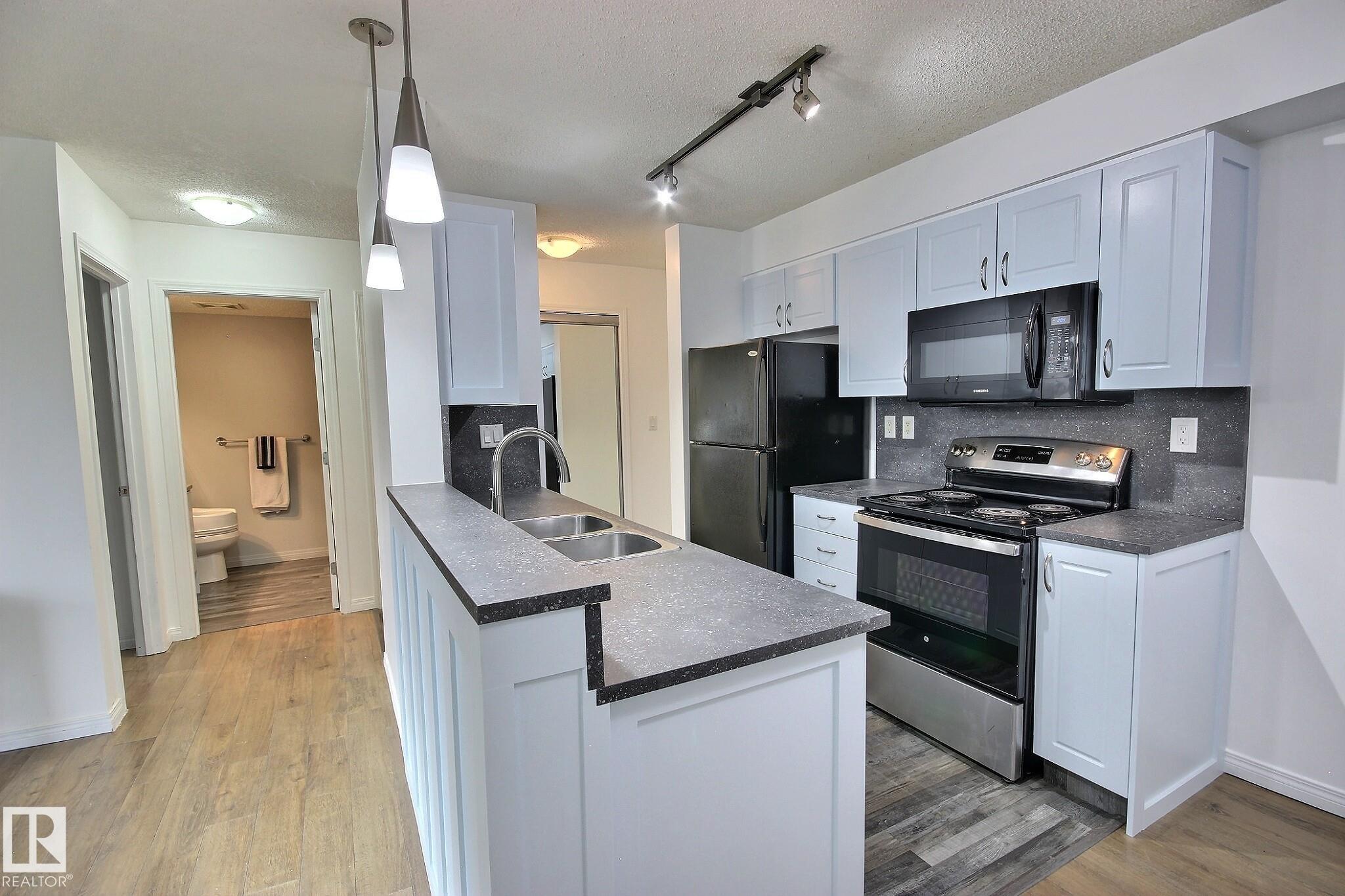 Clean and Convenient! This updated 2 bed/2 bath on a quiet street has everything you have been waiting for. Fully reno'd kitchen with attention to detail including counters, backsplash, gables, faucet, cabinets, etc. Other convenient features include laminate and vinyl plank flooring throughout (no carpet), in suite laundry, underground heated parking, painted, private setting, mirrored closets, walkable to many amenities and All Utilities included in the condo fees! Bathrooms also have updated cabinets and flooring! The unit is situated perfectly making it cool in the summer and warm in the winter. Patio faces east for peaceful morning coffee and cool mid summer BBQ's (nat gas hookup on patio). Lovely open green space directly out the patio doors for kids or a pet to play. The building is wired for Telus Fibre Optic which is great for those who work from home. Whether you are investing, upgrading or right-sizing, this is a fantastic option in a wonderful building! Immediate possession is available.