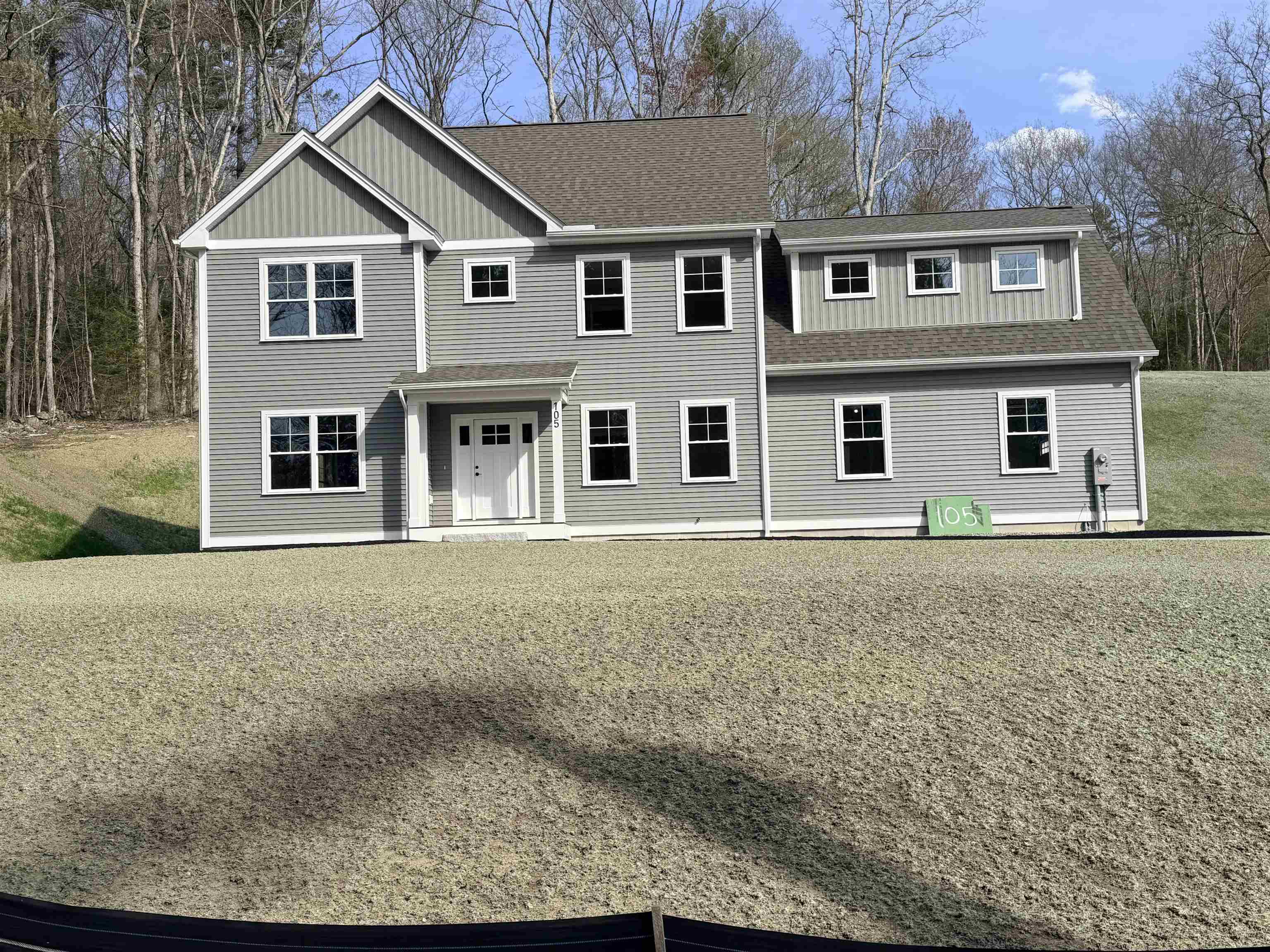 Construction is nearing completion on this ±2,621 square foot Colonial offering four bedrooms, two and a half bathrooms and a thoughtfully designed layout for modern living.  The first floor features 9-foot ceilings and an open floor plan connecting the kitchen, dining, and living areas with a gas fireplace; ideal for both everyday living and entertaining.  The kitchen is well-appointed with quartz countertops, soft-close cabinetry, a tile backsplash, gas stove, under-counter microwave and a hood vent.  Upstairs, Bedrooms 2 and 3 each feature walk-in closets. The primary suite offers a tiled shower, two walk-in closets and a spacious layout with flexibility for a variety of furniture and design options.  Additional highlights include a first floor study, mudroom, second-floor laundry, and a spacious two-car garage.  The unfinished basement provides ample storage and potential for future expansion.  Energy-efficient heating and cooling systems, along with an on-demand water heater, add to the home’s comfort and efficiency.  The exterior features durable vinyl siding, gutters, large energy-efficient Harvey windows and vinyl trim wrapped around the facia, windows and doors, adding to the home's low maintienance appeal.  A stone paver walkway and composite decking further enhances both the entry and overall curb appeal.  Please do not enter the property without an appointment.