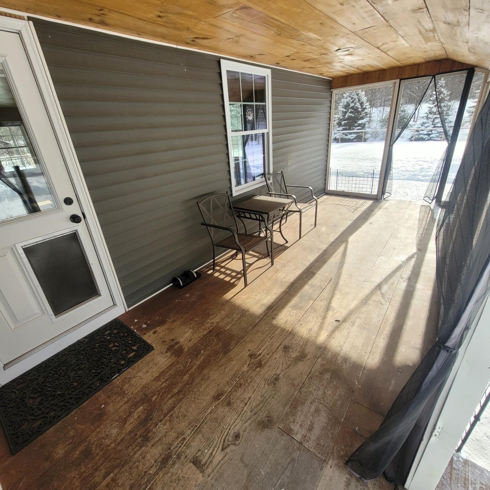 Screened in covered porch with dog door access