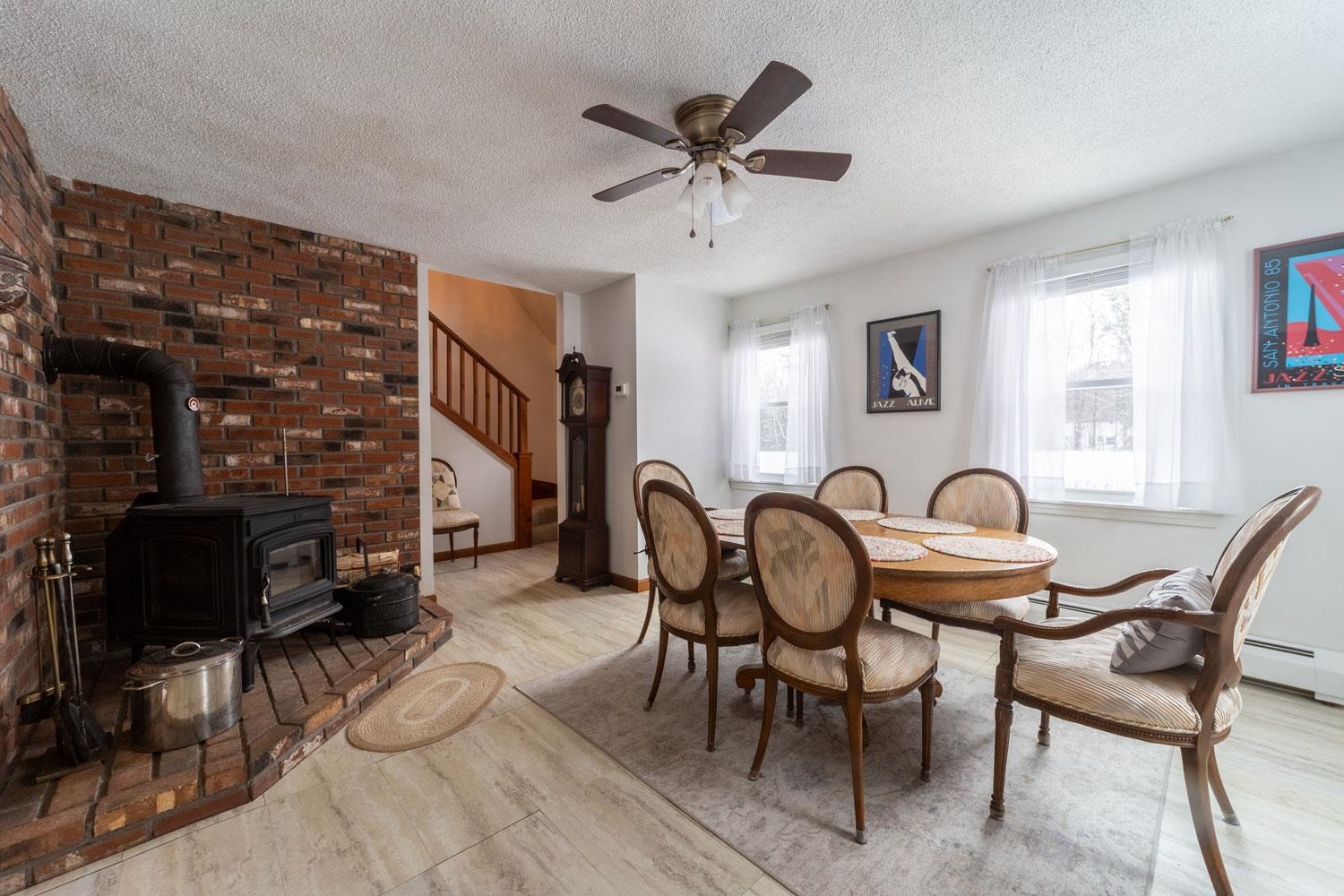 Spacious dining room enhanced by a ceiling fan for added comfort year-round.