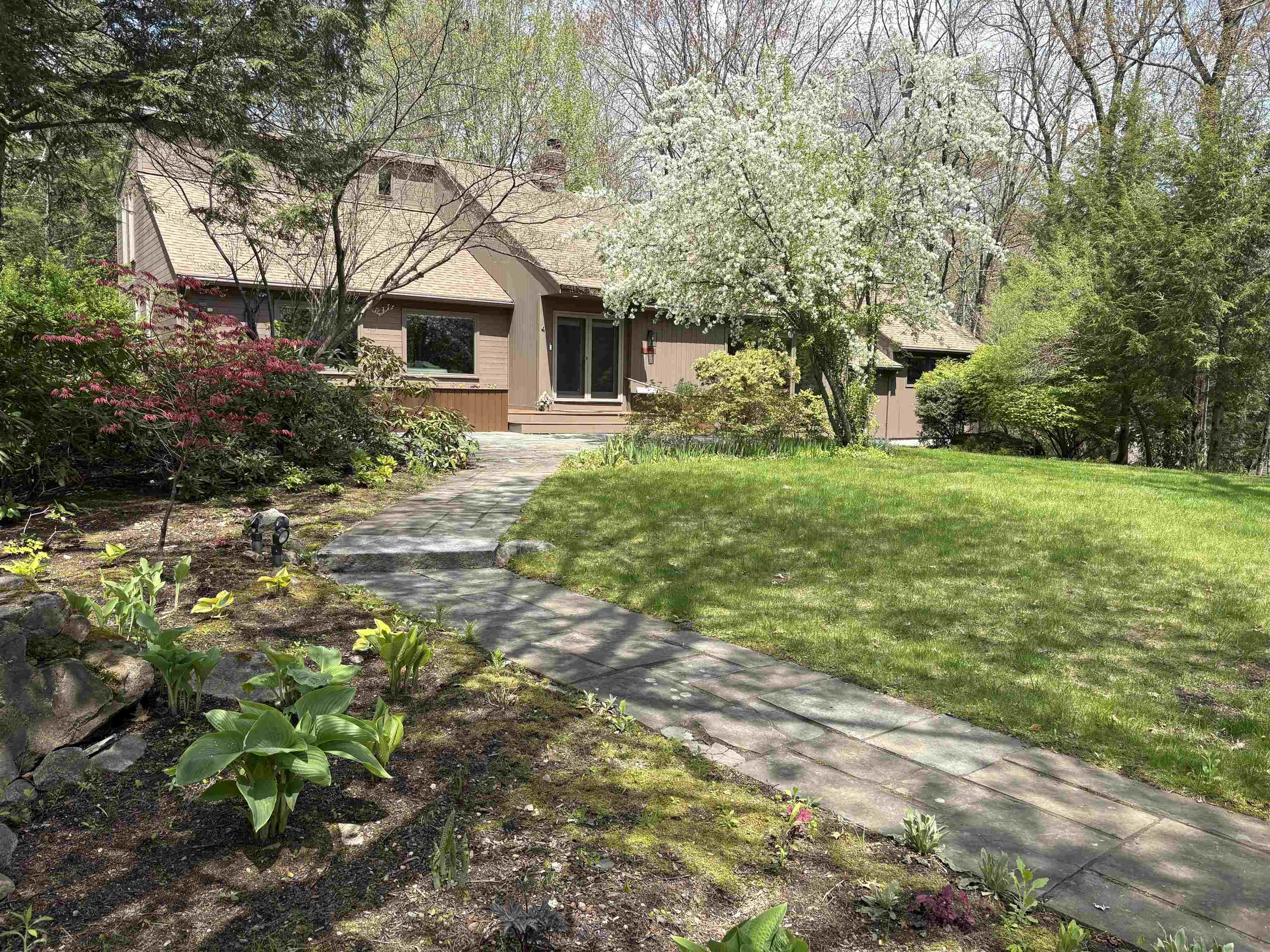 Truly One of Londonderry's Best! Discover an exceptional custom-built contemporary home, beautifully updated & meticulously cared for over the past four decades. From the moment you enter, it’s clear, this fine home offers a unique blend of thoughtful design, quality craftsmanship, modern comfort. The extensive landscaping and mature shrubs offers a Park-like setting! This expansive home provides remarkable flexibility, including 2 potential primary suites, one on first floor and 2nd floor, each featuring a custom oversized full bathroom and generous closets. With 3–4+ potential bedrooms, additional partially finished rms ideal for office, gym, creative hobby spaces. The layout adapts easily to a wide variety of lifestyle! The gourmet, updated kitchen is a standout feature, designed to impress with its custom finishes, expansive breakfast bar, and abundant workspace perfect for everyday living or hosting memorable gatherings. The adjoining two-story family room showcases a warm fireplace and large windows that fill the space with natural light, creating a warm and inviting atmosphere. Convenience continues with central air conditioning, a first-floor laundry room, and a beautiful blend of quality hardwood, and tile flooring throughout the home.  Recent improvements include a newer roof and a newly installed on-demand propane generator, adding peace of mind and efficiency. Outdoor living is just as impressive, featuring a spacious 700 sq ft private deck and an inviting front patio—ideal for relaxing & entertaining! Numerous thoughtful updates throughout the home contribute to its move-in-ready feel, offering the character of a long-loved property with the freshness of one that feels newly built. Enjoy the charm and warmth of wood and soaring ceiling!  The current owners have cherished this remarkable home for many years, and now it is ready to welcome its next chapter. Come see all the possibilities and discover the comfort, function, and style this property offers.