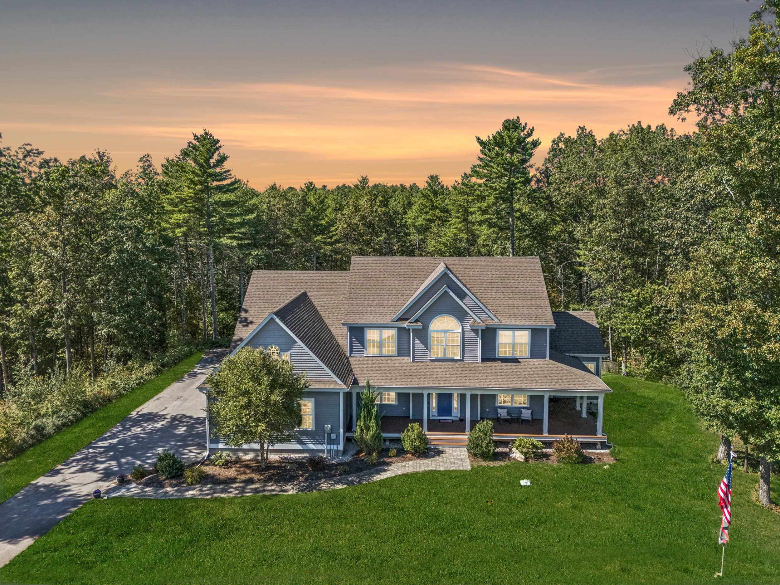 Welcome to Highclere, an elegant and thoughtfully designed home that blends timeless style with modern comfort. Built in 2019 in a 32 lot high end subdivision in highly desired Windham NH for it's excellent school systems and easy access for commuting between NH and Massachusetts.  This home features five bedrooms and three and a half bathrooms offering a versatile layout ideal for everyday living and entertaining. The property includes a pool, patio, firepit, covered deck, and a heated oversize 4-car garage with a workshop that features 14-foot ceilings- perfect for accommodating car lifts or plenty of extra storage. The home offers two primary bedroom options, each with a full en suite bathroom. The one on the first floor includes private access to outdoor living areas; or the second on the upper floor is nearer the other bedrooms. With three additional bedrooms, the home provides flexibility for a variety of living arrangements. The three and a half bathrooms include modern fixtures and finishes. A full footprint unfinished walk-out basement with lots of natural light gives the opportunity for additional expansion if desired. The expansive indoor and outdoor living spaces are well suited for entertaining. The patio, wrap-around farmers porch and covered rear deck create seamless transitions between the interior and exterior of the home. The four-car garage is ideal for car enthusiasts or hobbyists needing secure, heated indoor workspace and storage for boats or toys.  A thoughtful layout, with high quality construction, that has been meticulously maintained makes this home an opportunity for comfortable and functional living.