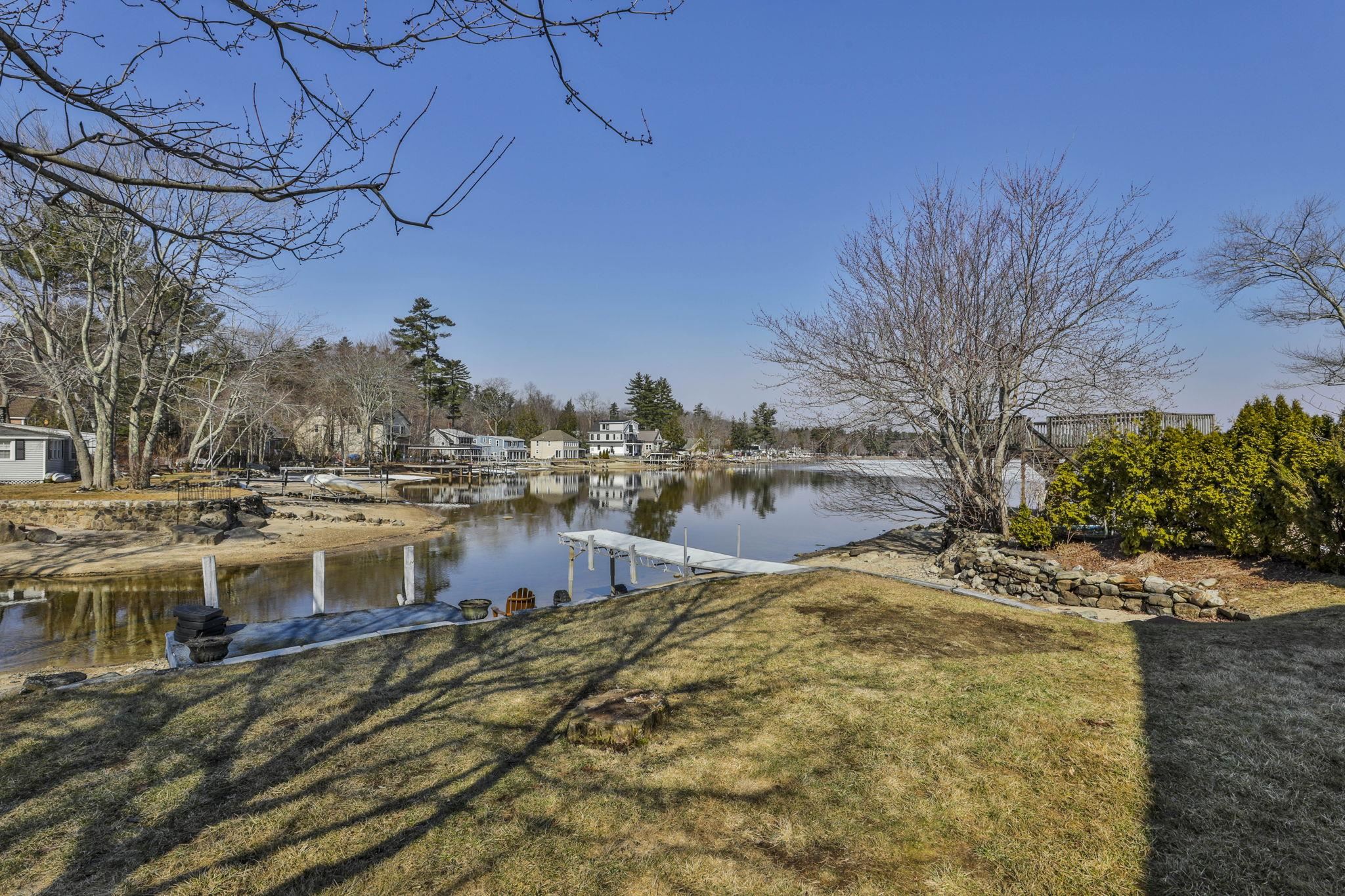 Year-round enjoyment awaits at this special waterfront retreat on Big Island Pond. Tucked away in a peaceful setting, this home offers the perfect blend of relaxation and entertaining, with stunning water views as your everyday backdrop. The open-concept kitchen and living area is designed for effortless living, featuring sliding glass doors that open to a level yard, private dock, and sandy shoreline—ideal for swimming, boating, or simply unwinding by the water. Generous outdoor space makes hosting gatherings a breeze, and an outdoor shed provides convenient storage for kayaks and seasonal items. The fully applianced kitchen features tiled countertops, a breakfast bar, and beautiful pond views. A cozy gas fireplace adds warmth and charm, while radiant heated floors in the upstairs bathroom provide an extra touch of comfort. Upstairs, you’ll find two bedrooms, a full bath, and a flexible den or office—perfect for remote work or guest space. The first level offers an additional bath and convenient laundry area. A rare opportunity to experience waterfront living in every season. First showings will be at open house Saturday 3/28 10-12 & Sunday 3/29 11-1.