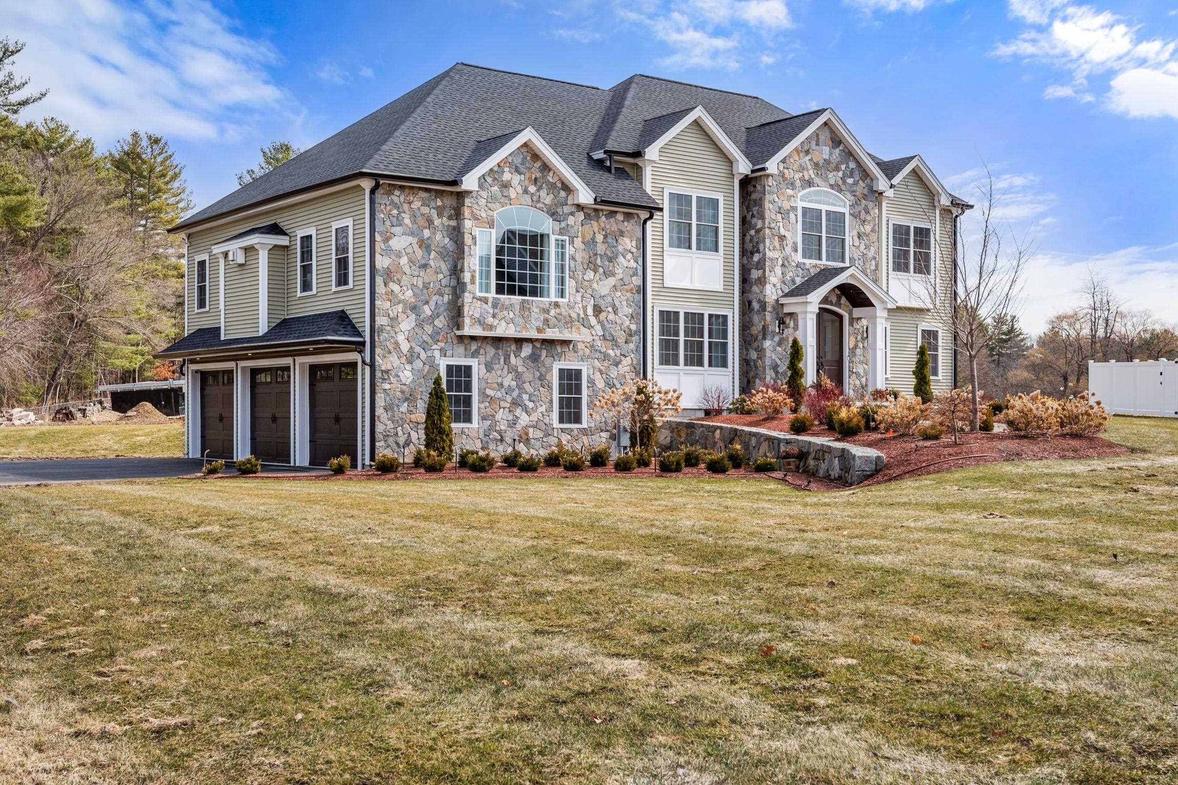Set gracefully along the coveted Hollis, NH border in one of Nashua’s most desirable enclaves, this two-year-young custom Colonial presents a rare opportunity to own the builder’s personal residence on an intimate luxury home cul-de-sac. Welcome to 5 Osprey Lane where refined craftsmanship meets timeless design. Thoughtfully curated for elevated living and effortless entertaining, the home unfolds with exceptional detail and scale. The dramatic great room showcases soaring 13-foot ceilings, creating an architectural focal point filled with light and dimension. A sophisticated wet bar enhances the space, offering the perfect setting for both intimate gatherings and grand entertaining. At the heart of the home, the stunning chef’s kitchen is a true showpiece. Custom natural quartzite surfaces, premium appliances, bespoke cabinetry, and a built-in private wine showcase reflect the elevated finishes expected in a builder’s own residence. Every element blends elegance with everyday functionality. With four generously proportioned bedrooms and three beautifully appointed baths, the home offers comfort, flexibility, and modern convenience. Refined finishes, natural light, and a cohesive design palette flow throughout. The lifestyle is equally compelling. Ideally positioned near the Nashua Rail Trail for biking and jogging, and moments from private and public golf courses and country clubs, recreation is always within reach. Proximity to highly regarded public and private schools further enhances the location’s appeal. Private. Sophisticated. Exceptionally built and room to expand with a large unfinished lower level and 5 bedroom septic approval. A rare offering in one of Southern New Hampshire’s most sought-after settings.