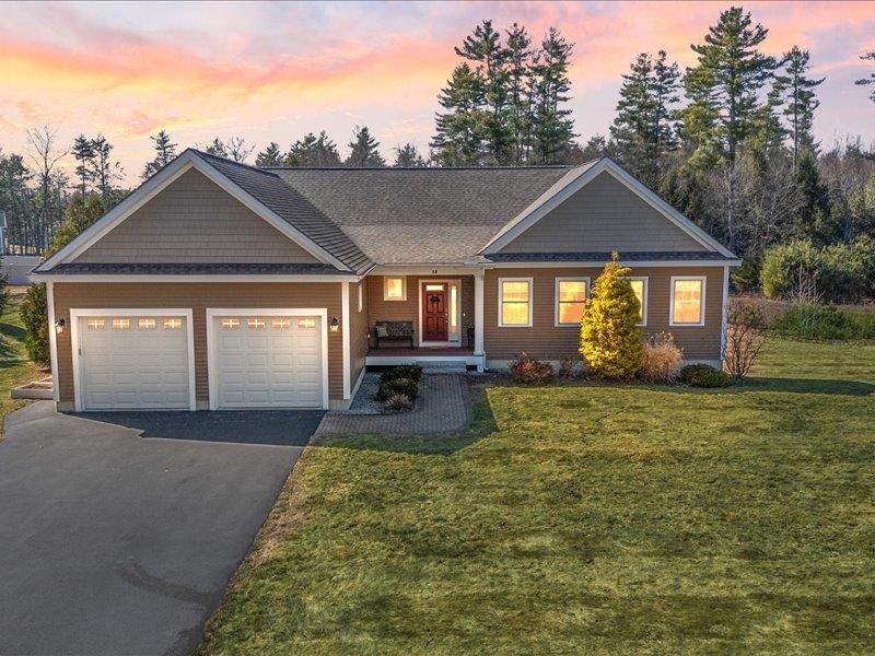 This home is a true gem! A welcoming front porch offers the perfect spot for rocking chairs to enjoy the surrounding quiet. Inside, the spacious entryway features ample room for storage, a large closet, and convenient garage access.  The heart of the home is a stunning great room, where gleaming hardwood floors and soaring cathedral ceilings reflect an abundance of natural light. This space flows seamlessly into a modern kitchen boasting white shaker cabinetry, stainless appliances, granite countertops, and a clever multi-purpose pantry/laundry suite. Nearby, a beautiful sunroom with walls of windows leads directly to the back deck.  The primary suite is a private retreat featuring vaulted ceilings, dual walk-in closets, and a luxurious ensuite bath with a double-sink vanity, granite counters, and a custom tile-and-glass shower. Two additional bedrooms—both with 9-foot ceilings and large windows—share a well-appointed full bath.  Need more space? The walk-out basement offers 1,900 sq. ft. of daylight-filled potential, overlooking a level backyard and a lush natural wood line. Nature lovers will also appreciate being within walking distance of the Horse Hill Nature Preserve, featuring 563+ acres of hiking and biking trails. Check the photo gallery for a glimpse of the local wildlife!