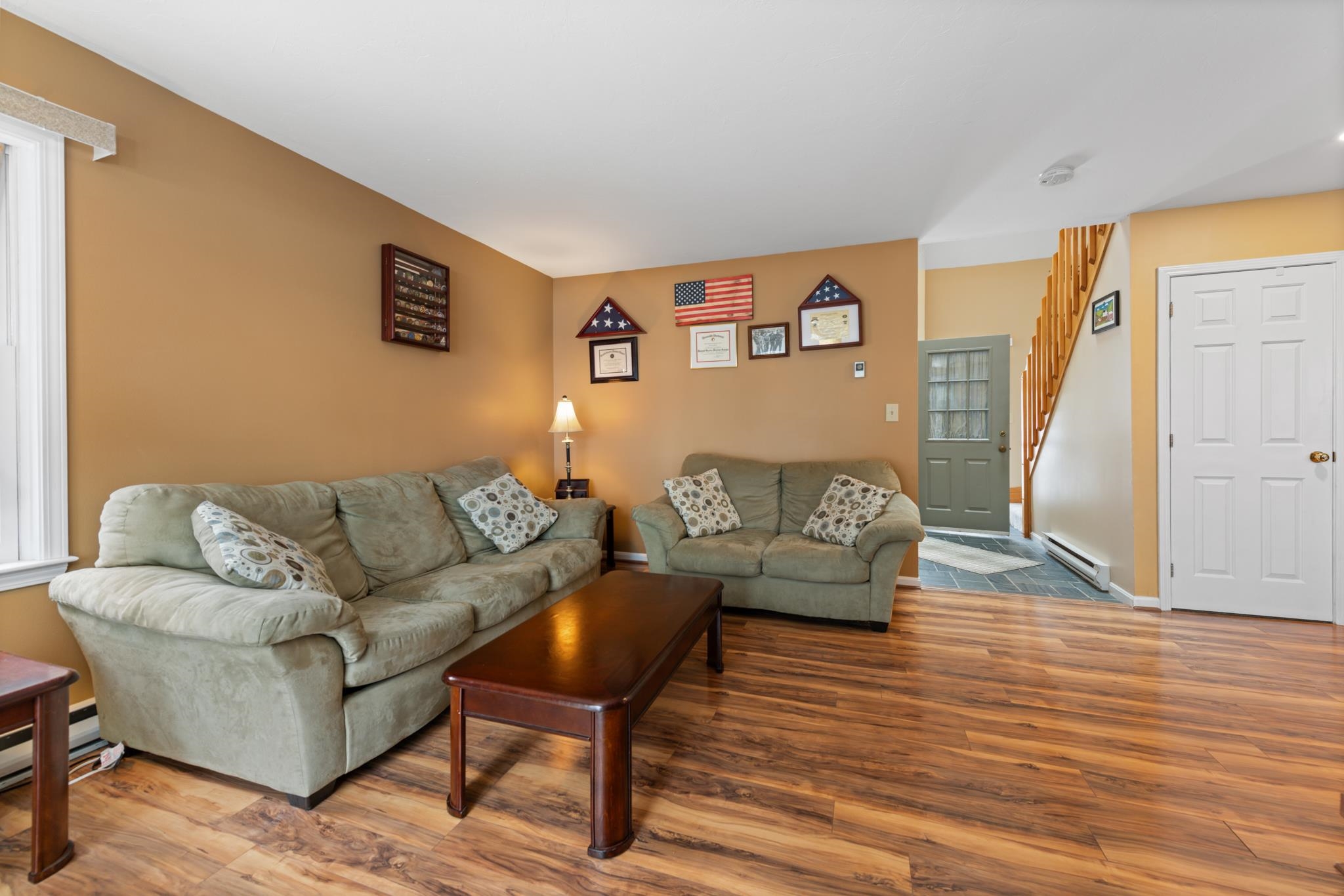 This living room is cozy and has natural light flooding in