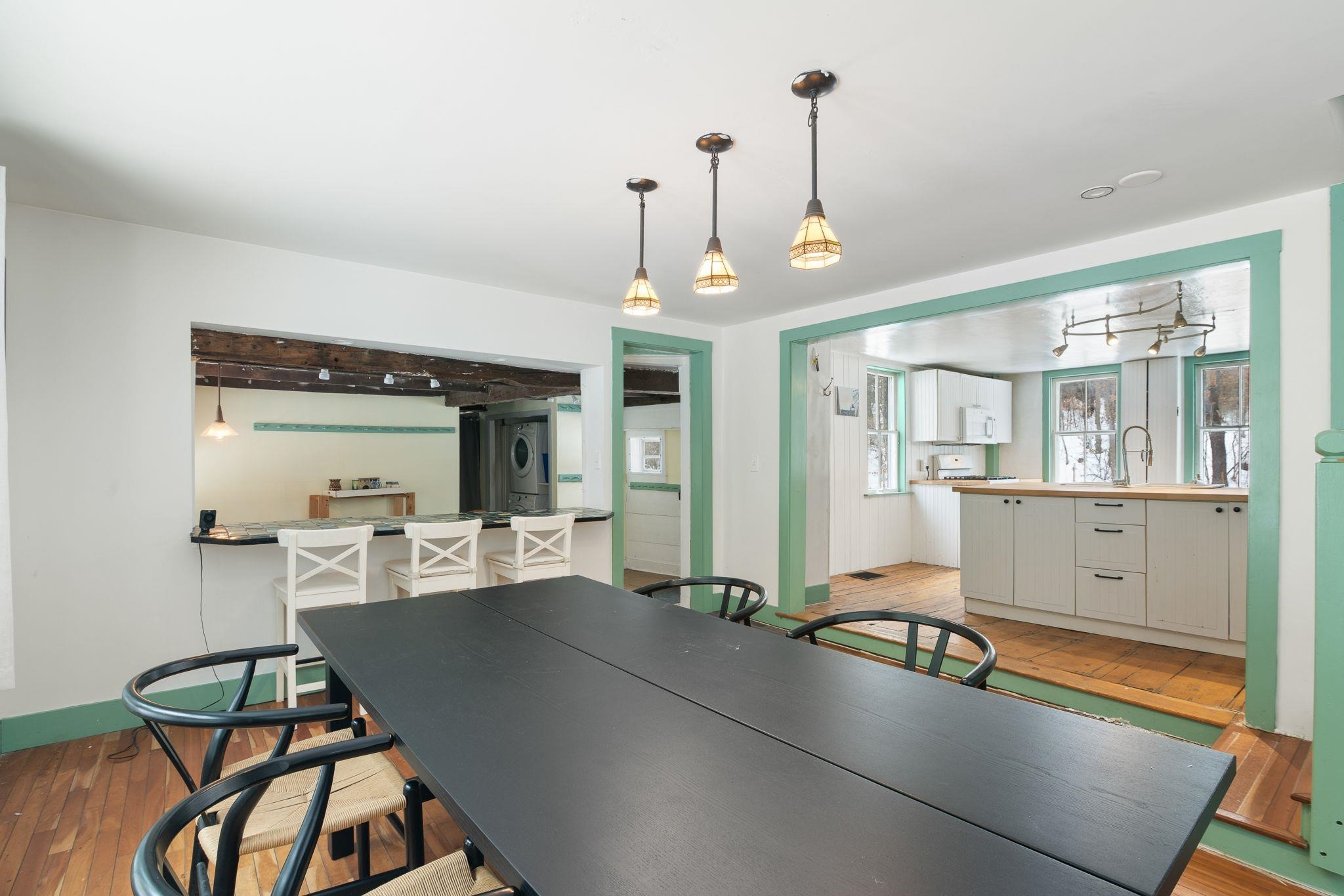 Dining view of kitchen, mudroom w/ washer & dryer.