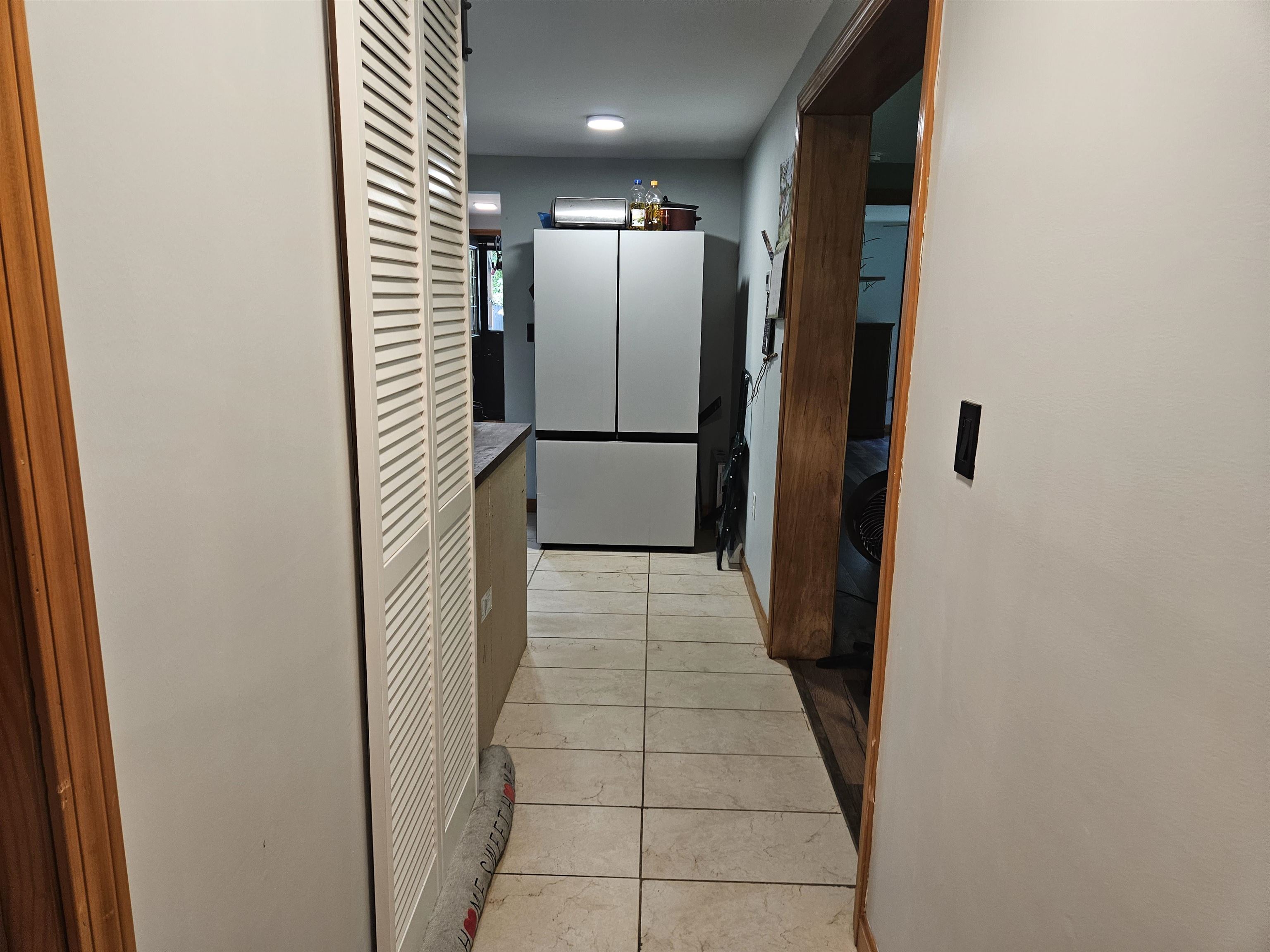 Hallway looking from blue bedroom towards kitchen