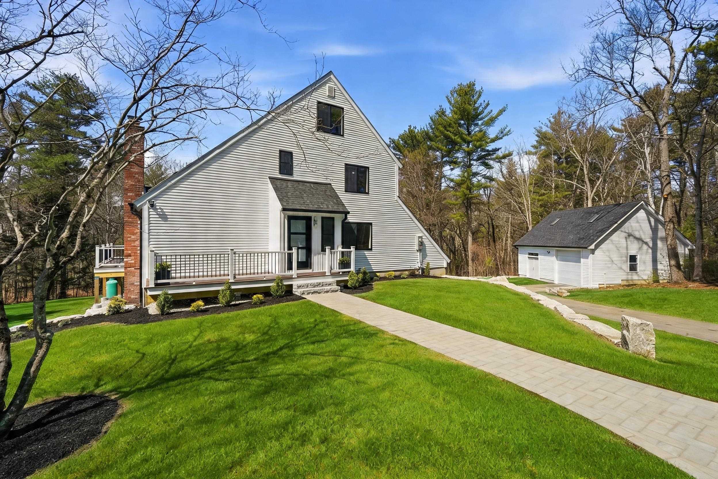 Introducing an exceptional, fully reimagined property set on 8.25 private acres at the end of a quiet cul-de-sac in highly desirable Windham, NH. This turnkey residence has been meticulously renovated from top to bottom with premium upgrades including new siding, windows, roof, gutters, heating system, central air, garage doors and expansive new decking. Designed for both comfort and sophistication, the home showcases an open layout, sun-drenched living spaces and high end touches. The gourmet kitchen has been beautifully updated with quartz countertops, plenty of counter and cabinet space, a unique Venetian plaster surround, and a fabulous bar area for casual eating and entertaining. Off the kitchen is a lovely sunroom leading out to the massive wrap around composite deck. Enjoy the views and sunsets from the deck overlooking the wooded back yard. The bathrooms feature elegant marble tile showers, quartz countertops, matte gold fixtures and clear glass shower doors. The master bedroom has its own private balcony overlooking the expansive backyard...a perfect retreat to relax and unwind. Each bedroom is spacious, light and bright with hardwood flooring. Multiple bonus rooms in this house include a finished attic, which could be an additional bedroom, office, movie room, play room...so many possibilities. The finished basement provides additional flex space and access to the back yard with walkout and daylight windows. Adding exceptional versatility, the detached garage presents a rare opportunity, as it exists currently as a workshop and massive oversized garage or for a potential future detached ADU, guest quarters or private workspace (water/septic in place). Surrounded by natural wooded beauty and privacy, this thoughtfully upgraded property delivers a perfect blend of luxury, acreage and modern convenience - just minutes from area amenities, and commuter routes. This unique property is truly one of a kind and not to be missed!