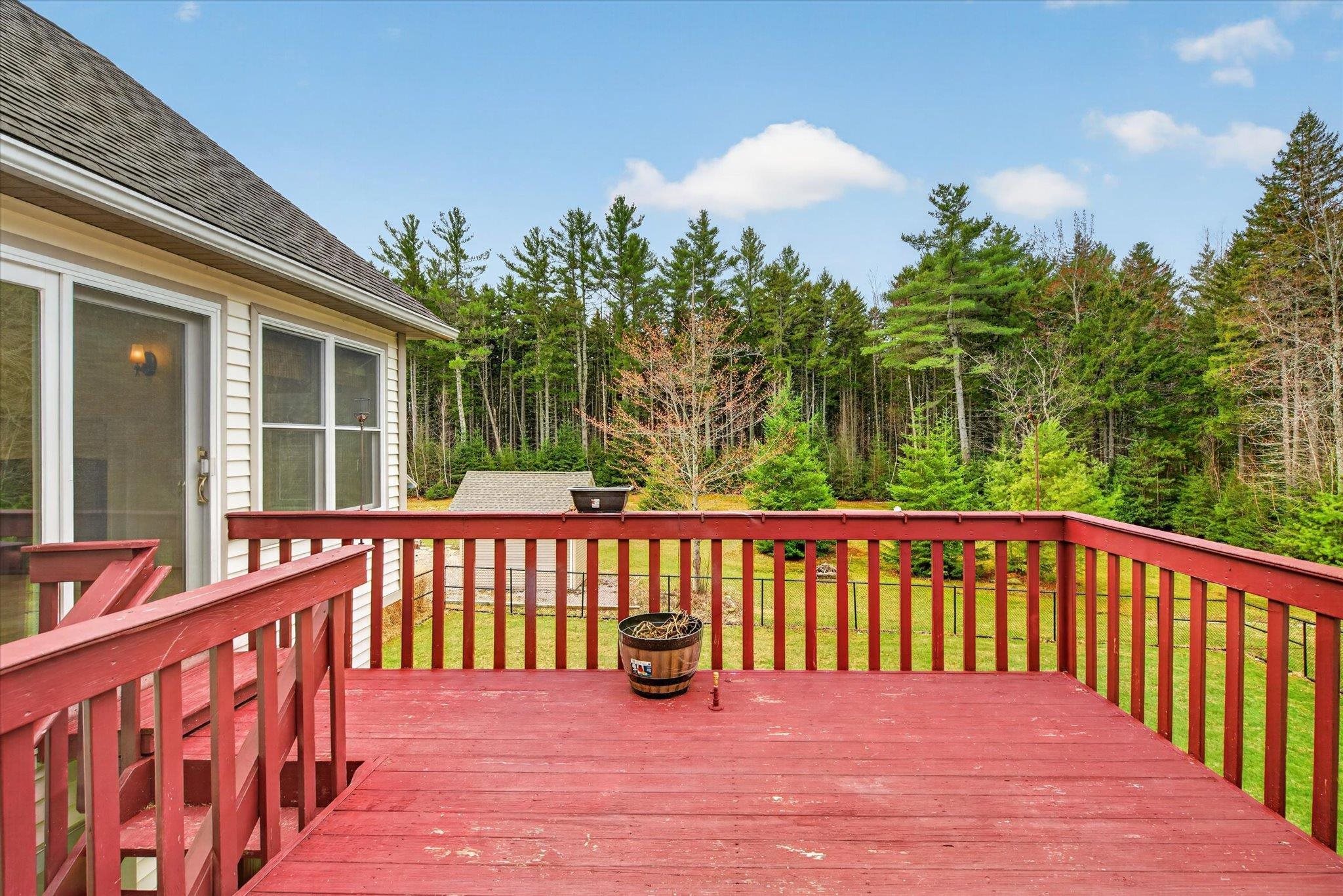 Large back deck overlooking level, lovely yard