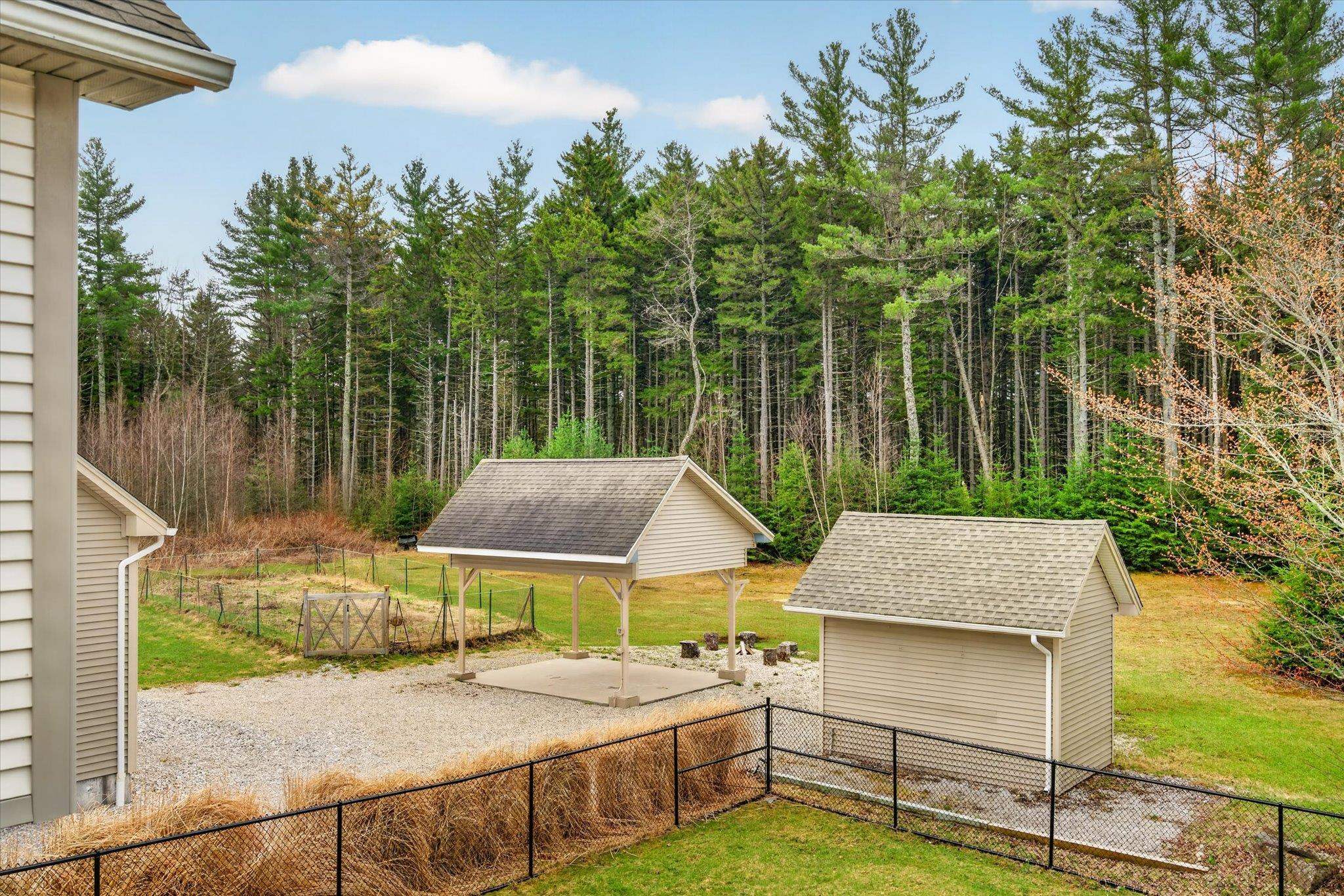 Fenced back yard with garden, pavilion and storage garage