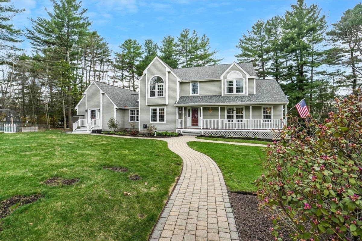 A truly one-of-a-kind opportunity in Nashua, New Hampshire—this contemporary-style Colonial offers exceptional space, versatility, and income or multigenerational living potential with a fully equipped accessory dwelling unit (ADU). Set on a beautifully landscaped corner lot, this property is designed for both everyday comfort and elevated living.  The main home features four spacious bedrooms, including a stunning primary suite with vaulted ceilings, a private bath, and a walk-in closet. Three additional guest bedrooms and a full bath provide ample space for family or guests. The first floor offers a thoughtful layout with a formal dining room, an eat-in kitchen with a large pantry, 1st floor laundry and a warm, inviting fireplaced living room—perfect for gathering and entertaining.  The attached ADU is equally impressive, offering its own private entrance and parking. Inside, you’ll find a bright and open-concept layout with a cathedral-ceiling kitchen, liviing room,  private bedroom, and bath—ideal for extended family, guests, or rental income.  Additional highlights include a two-car garage, separate private parking for each unit, and an expansive maintenance-free deck spanning the entire back of the home—perfect for outdoor dining and relaxation.  Located in a desirable Nashua neighborhood with easy access to shopping, dining, and commuter routes, this rare property delivers flexibility, style, and value. Homes like this are few and far between—don’t miss your chance to make it yours.