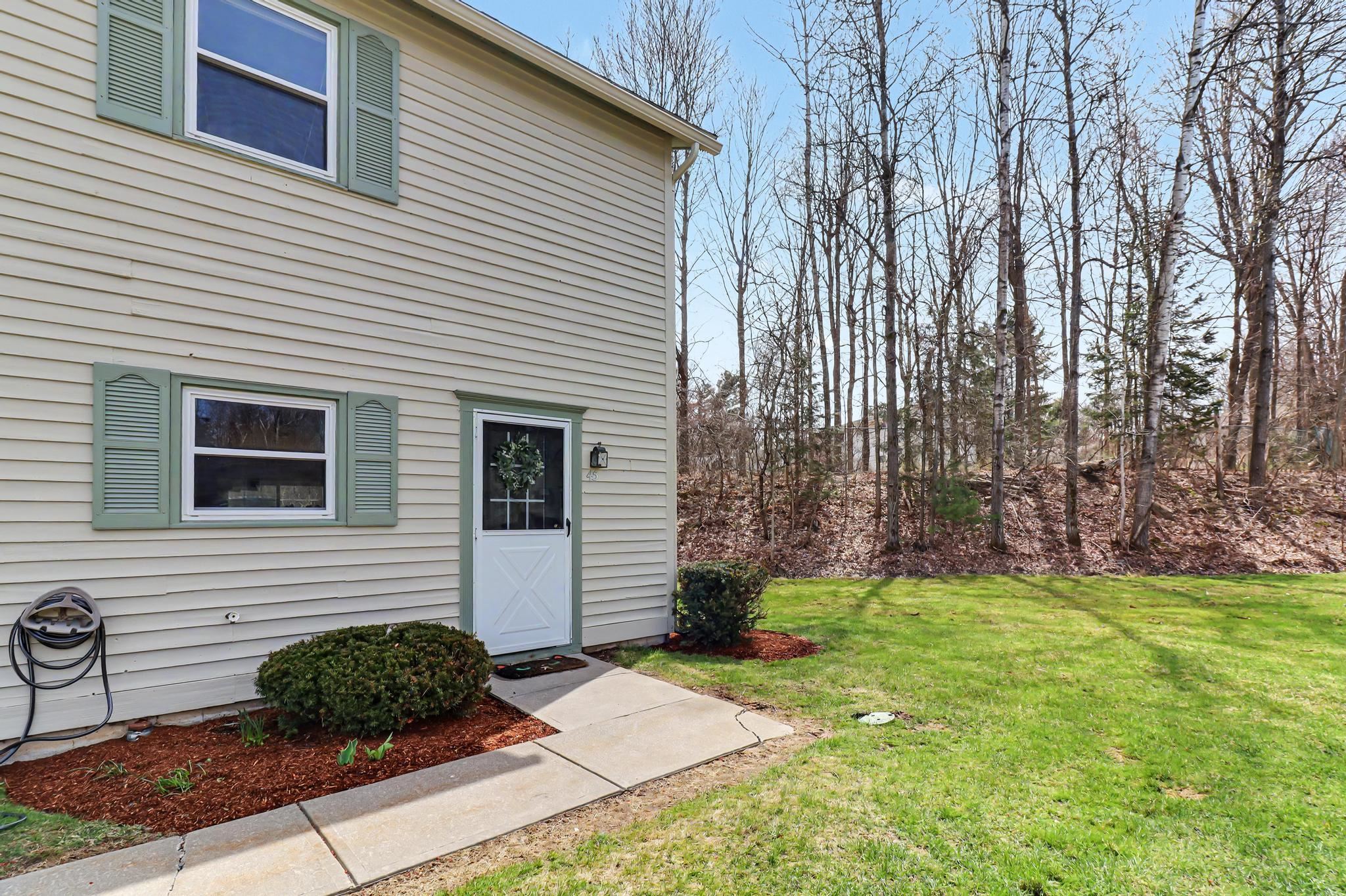 Bright and sunny, south-facing end-unit townhome in the desirable Village Glen neighborhood of Essex Junction! This inviting home offers an open-concept main level featuring a well-appointed kitchen with new microwave and stove, ample cabinet space, and a convenient adjacent half bath. The dining area flows seamlessly into a step-down living room, creating a comfortable and functional space for everyday living and entertaining.  Upstairs, you’ll find two spacious bedrooms, a full bath, and the added convenience of stackable laundry. Step outside to your private back deck overlooking a peaceful wooded setting—perfect for enjoying your morning coffee or relaxing on warm summer evenings.  Additional features include a carport with extra storage, one assigned parking space, and guest parking. Pets are allowed, adding to the flexibility and appeal of this home.  Ideally located just minutes from The Essex Experience, as well as shopping, dining, a movie theater, schools, parks, and public transportation. A fantastic opportunity in a prime location—perfect for first-time buyers or those looking to enjoy low-maintenance living!