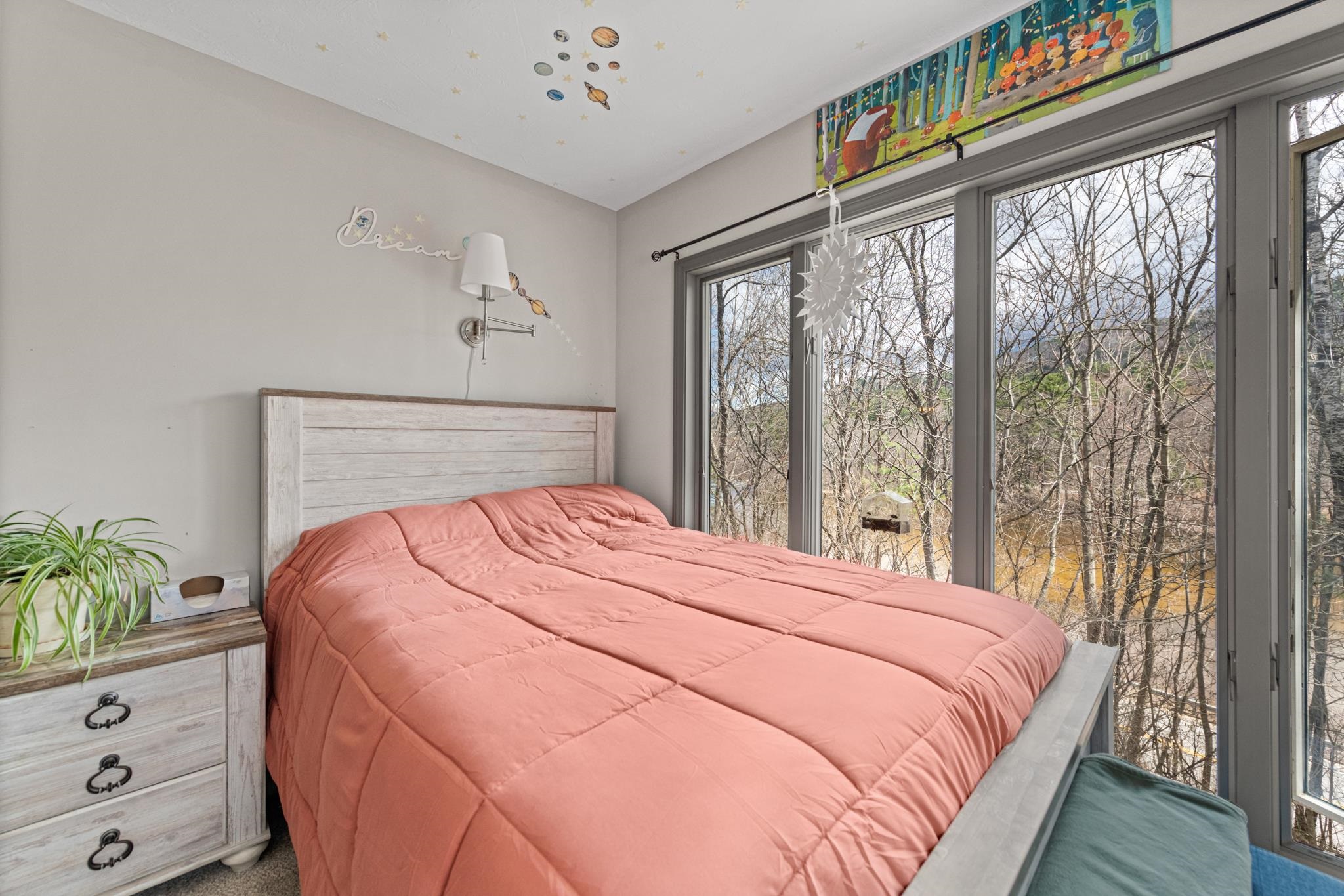 The 4th office/bedroom with large windows and new carpeting