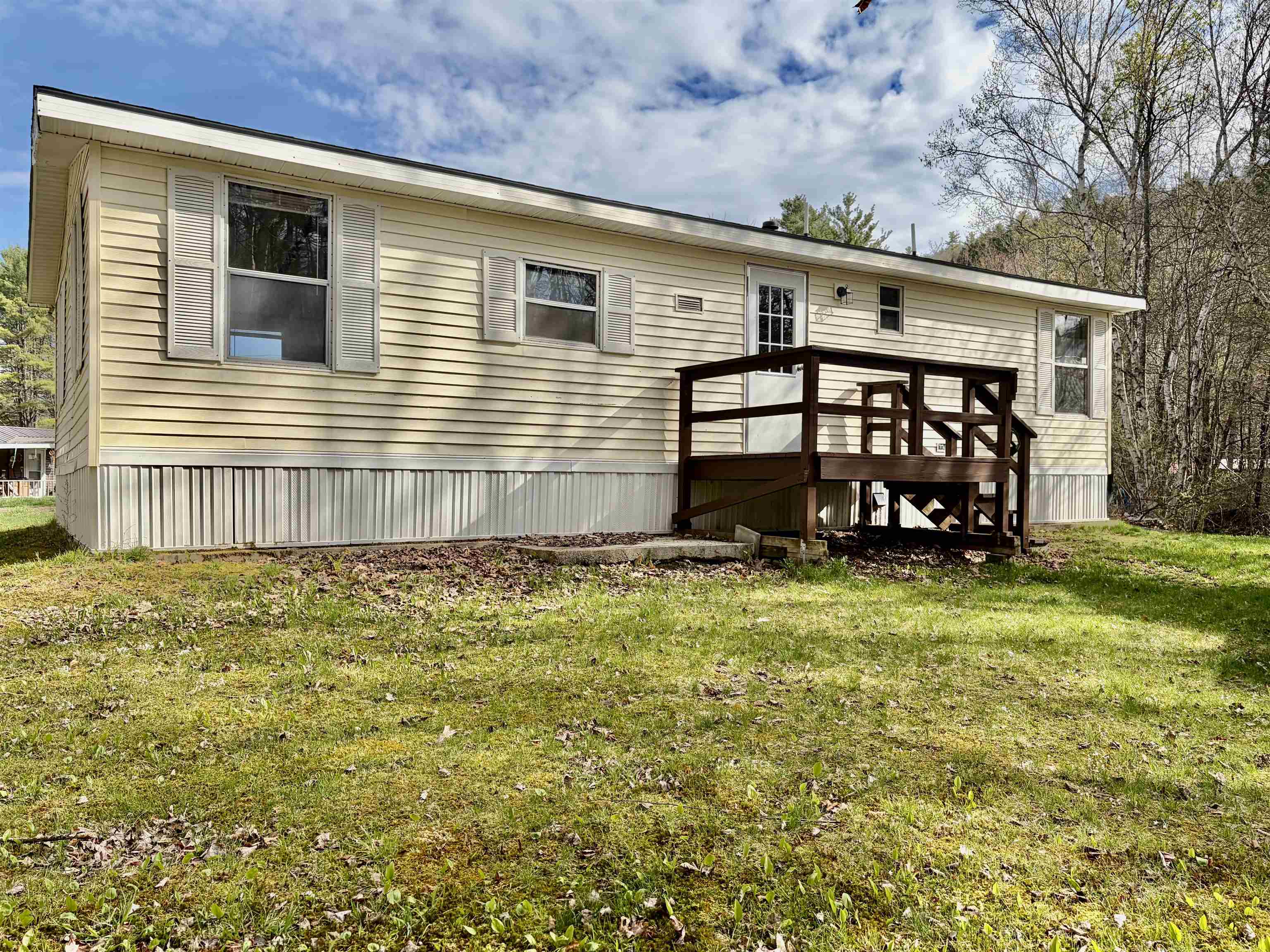 Back Yard with Deck and Bordered by a Stream