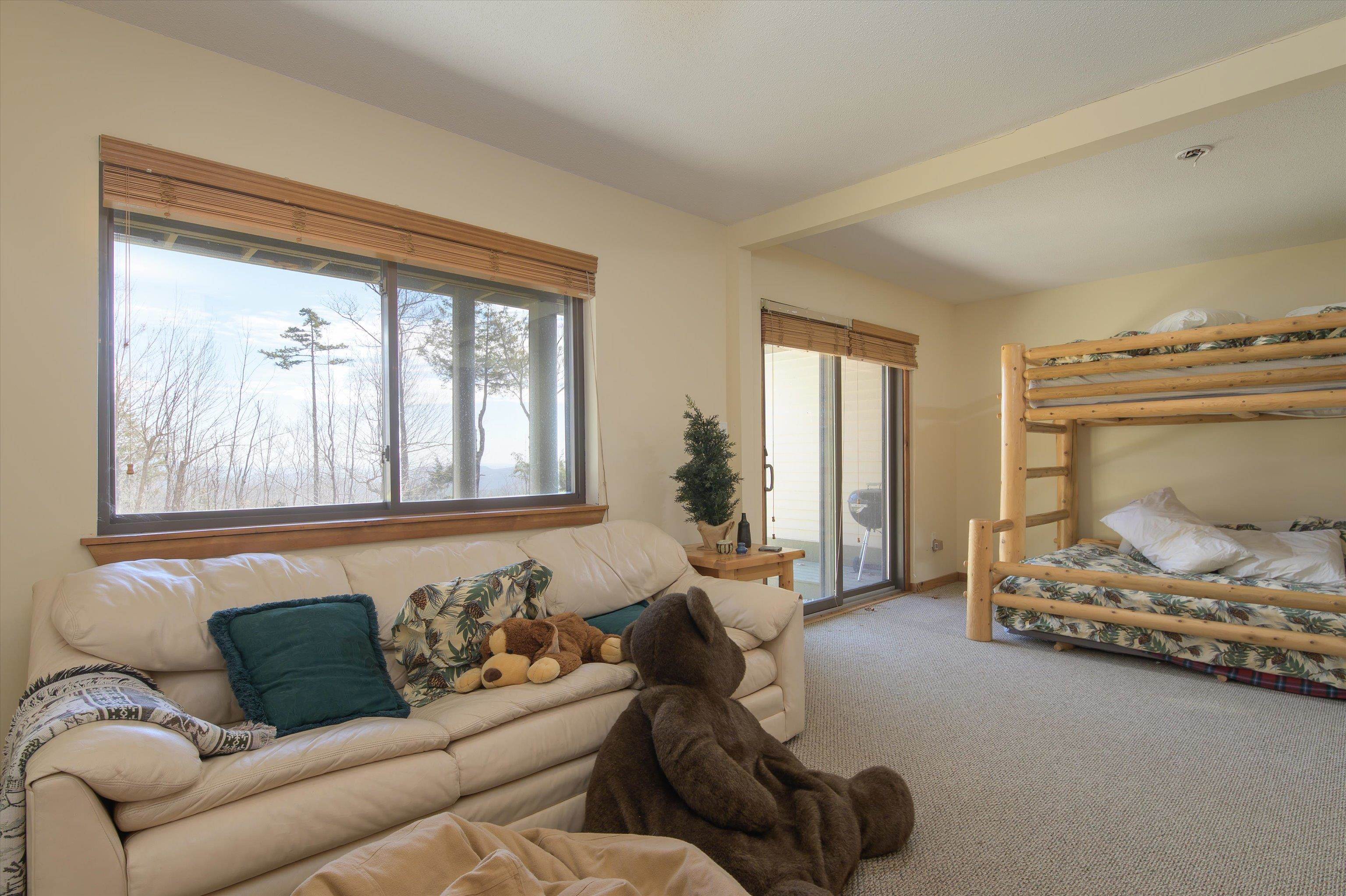 Large bunkroom leading out to exterior spaces and ski trail