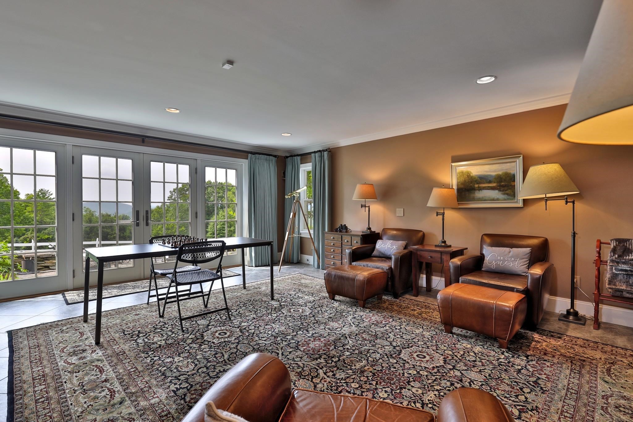 Spacious common area with doors to patio 25194072