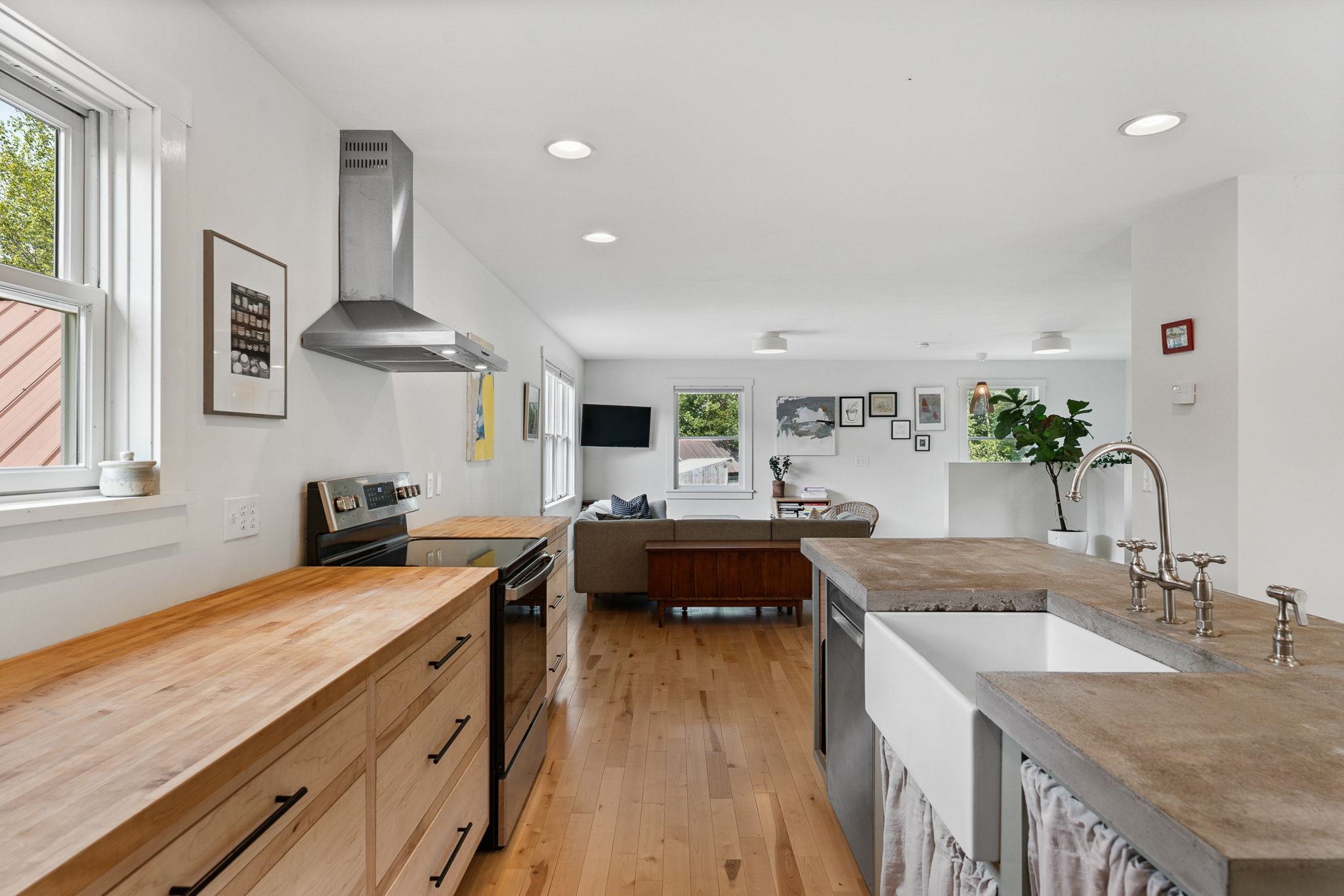 Island with concrete countertop and inlaid ceramic sink