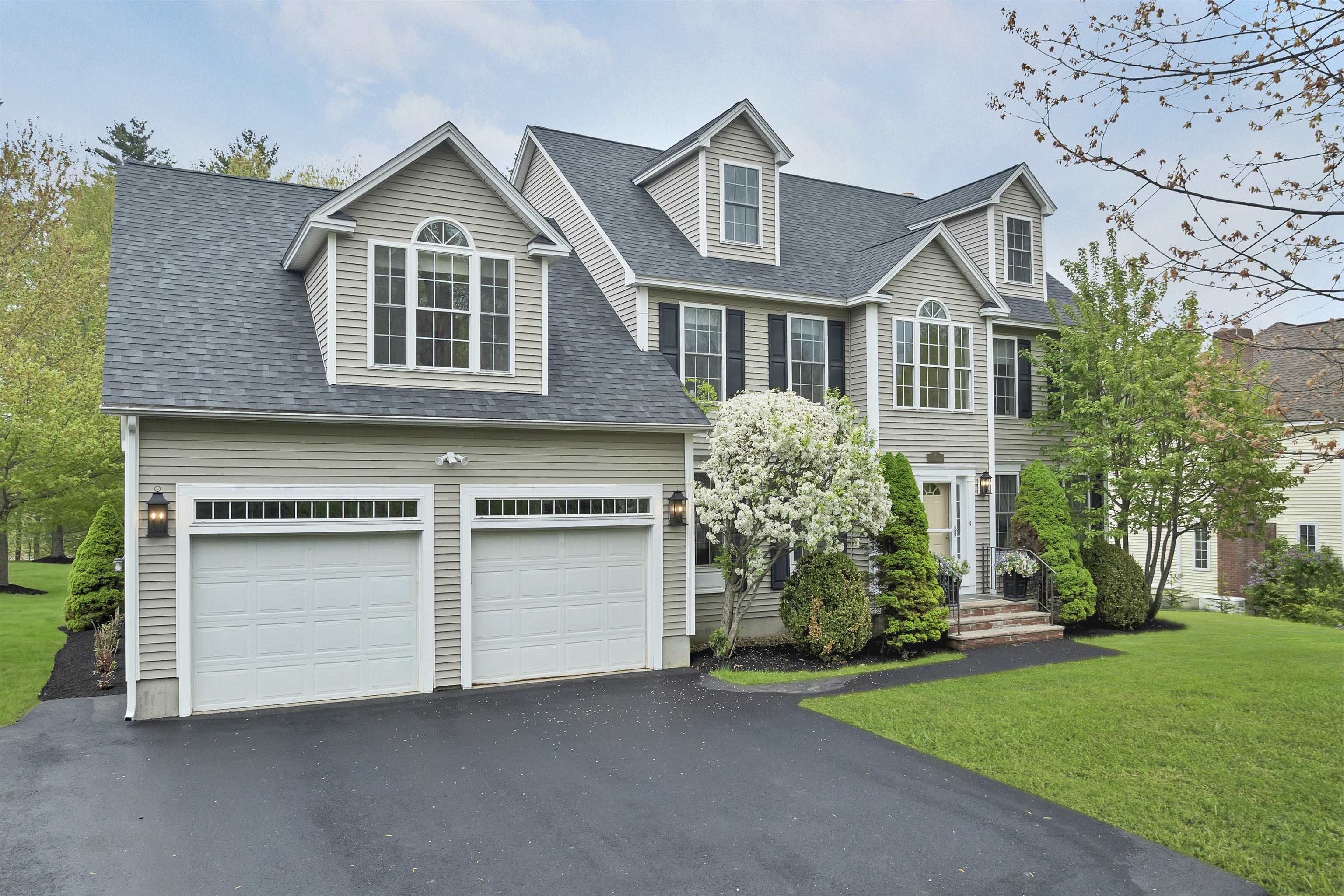This impressive, one-owner, 4-bedroom Colonial is nestled in a sought-after neighborhood featuring winding, walkable streets. Step into the two-story foyer, flanked by a formal dining room with elegant French doors and wainscoting, and a bright living room. The heart of the home is an open-concept family room and spacious kitchen, featuring a sunny breakfast nook surrounded by windows. From here, enjoy views of the large, level backyard—perfect for outdoor play—complete with a two-level deck and cozy firepit.  Recent updates include fresh paint, refinished hardwood floors throughout the first floor and two upstairs bedrooms, and brand-new carpet in the remaining rooms. The primary suite serves as a true retreat, boasting a spa-like bath with a whirlpool tub, dressing area, and two walk-in closets. Additional highlights include a large walk-up attic with windows and a sprawling basement ready for storage or future expansion. With a 5-year-old roof, a newly repaved driveway, repainted decks, and updated lighting and smoke detectors, this lovingly maintained home is ready for you to move right in.
