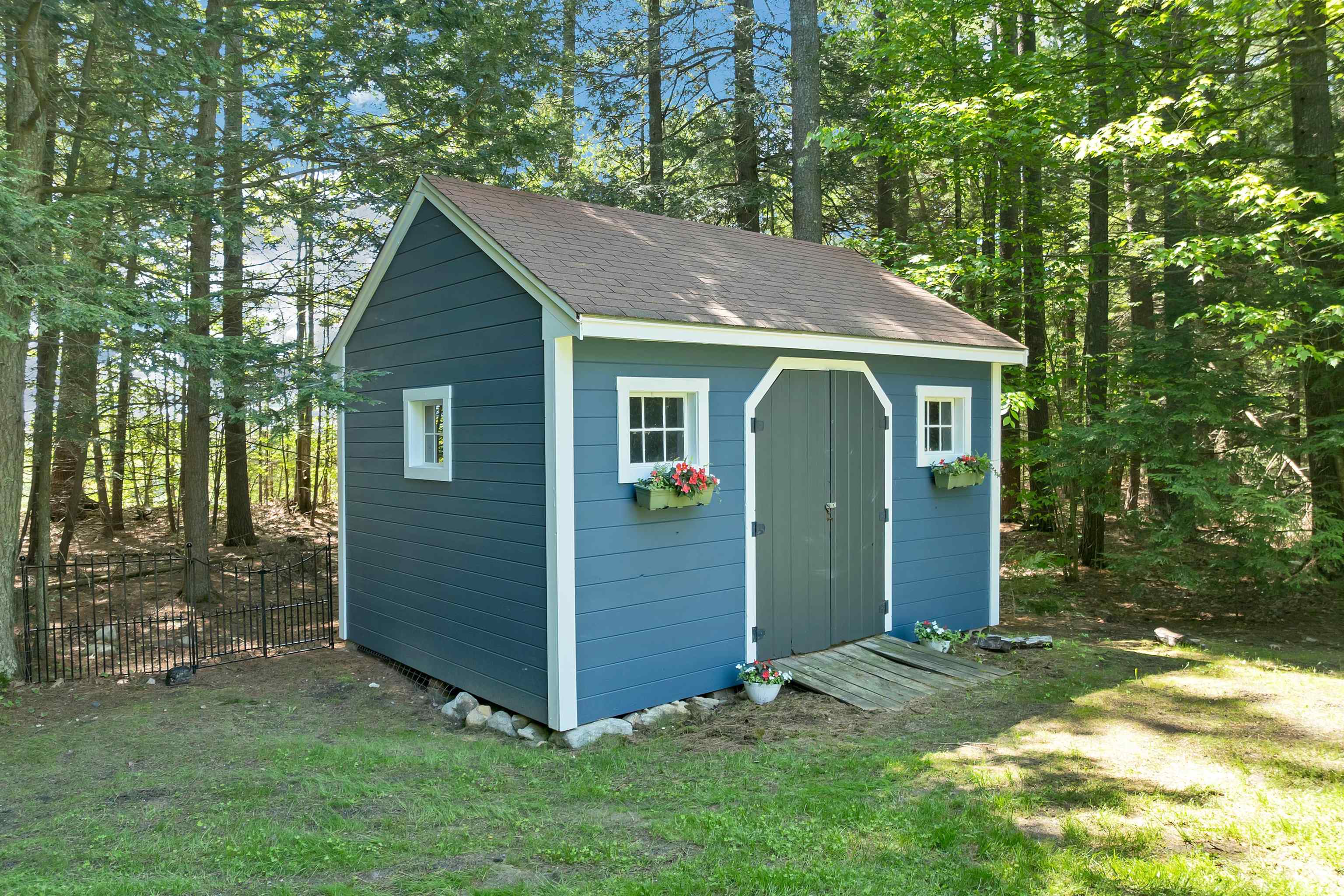 A picture-perfect shed tucked into the wooded setting
