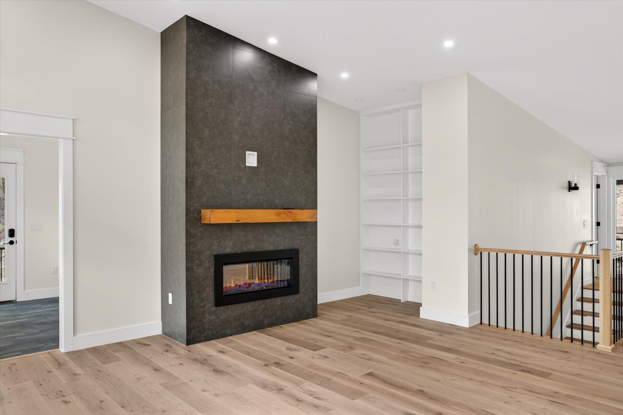 Mudroom access to the left of the electric built in fireplace