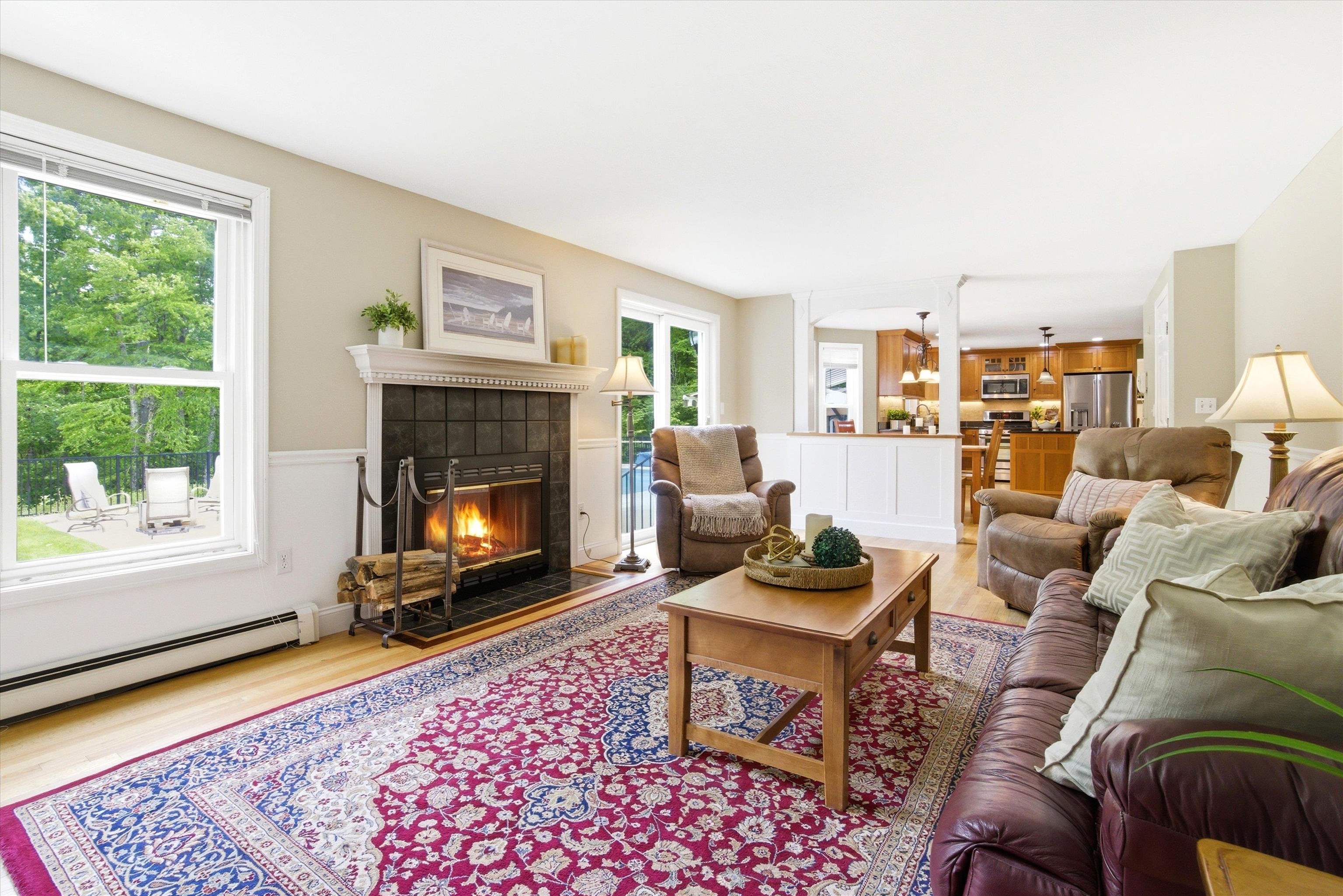 Comfortable gathering space with a real wood-burning fireplace and seamless flow to adjoining rooms.
