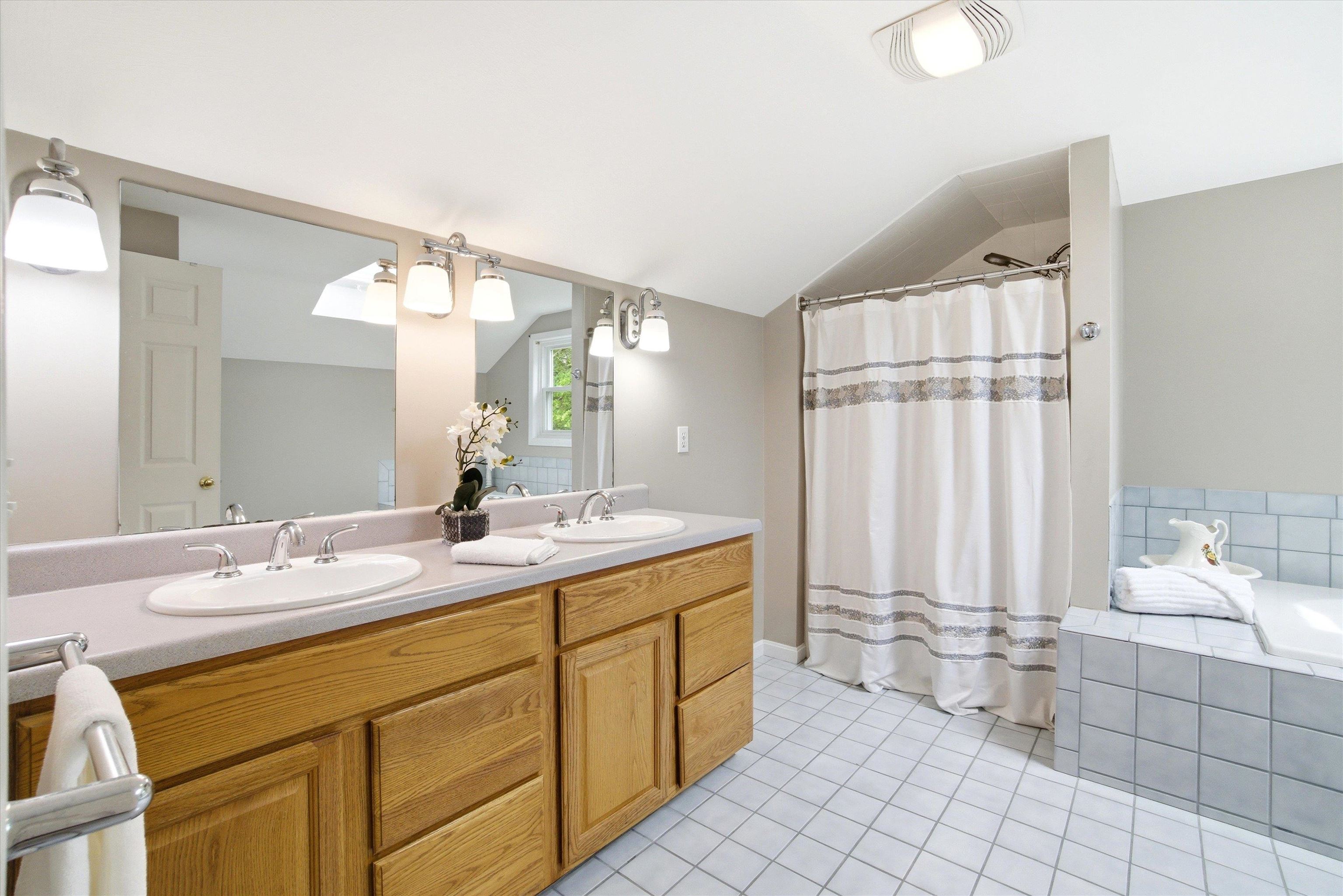 Well-appointed bathroom featuring a double vanity and plenty of storage.