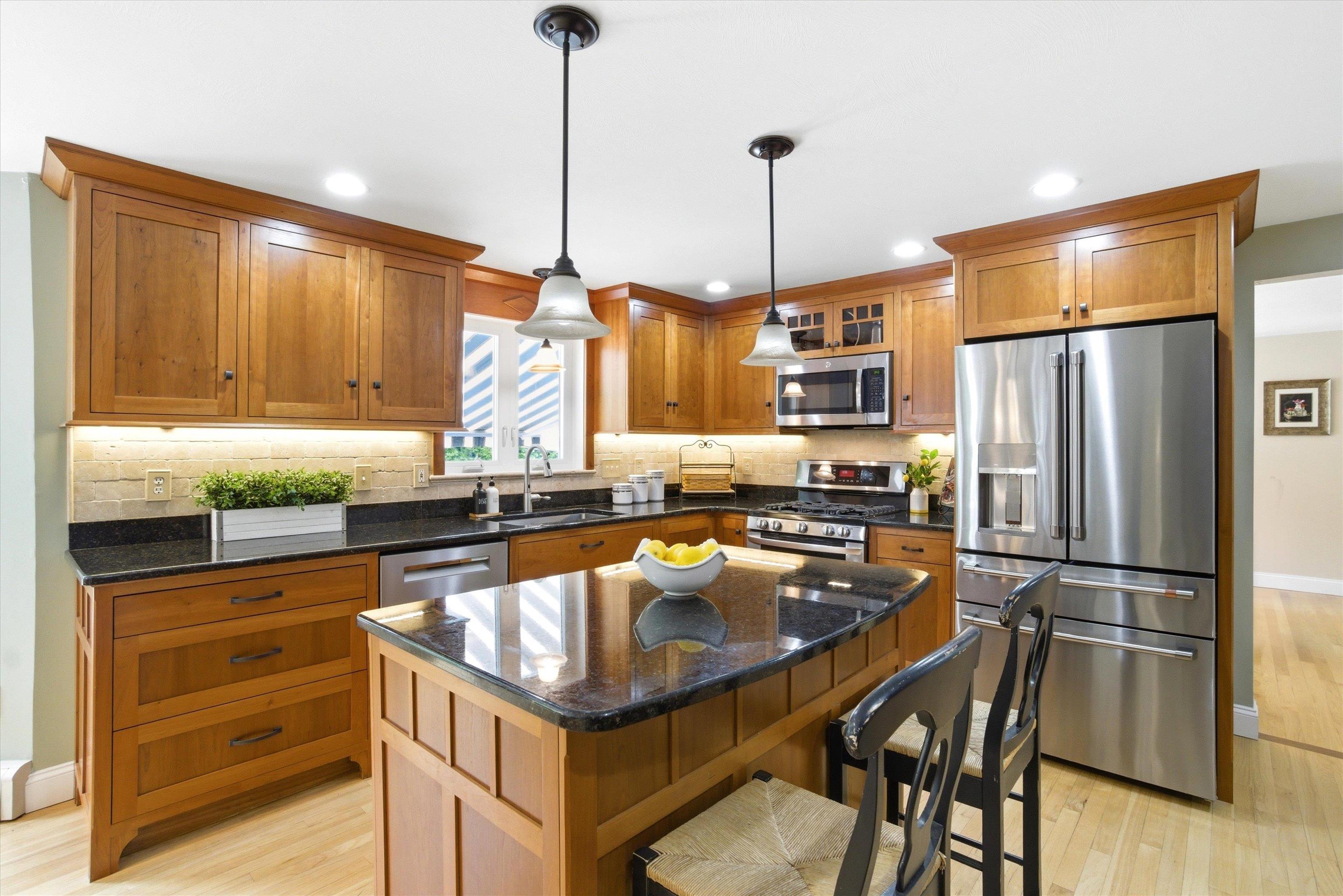 Custom cherry kitchen with newer appliances.
