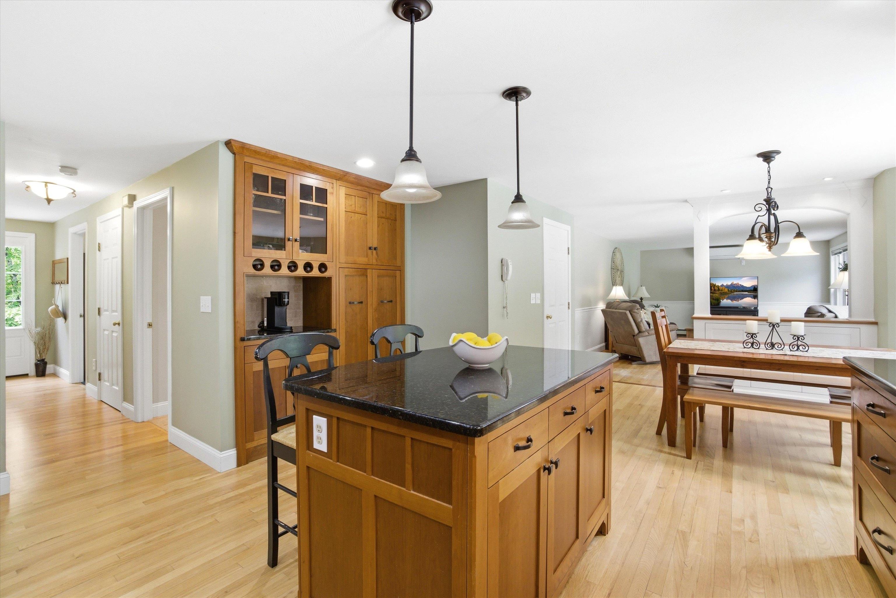 BEAUTIFUL CUSTOM CHERRY CABINETRY W/ center island, storage aplenty, and open sightlines.