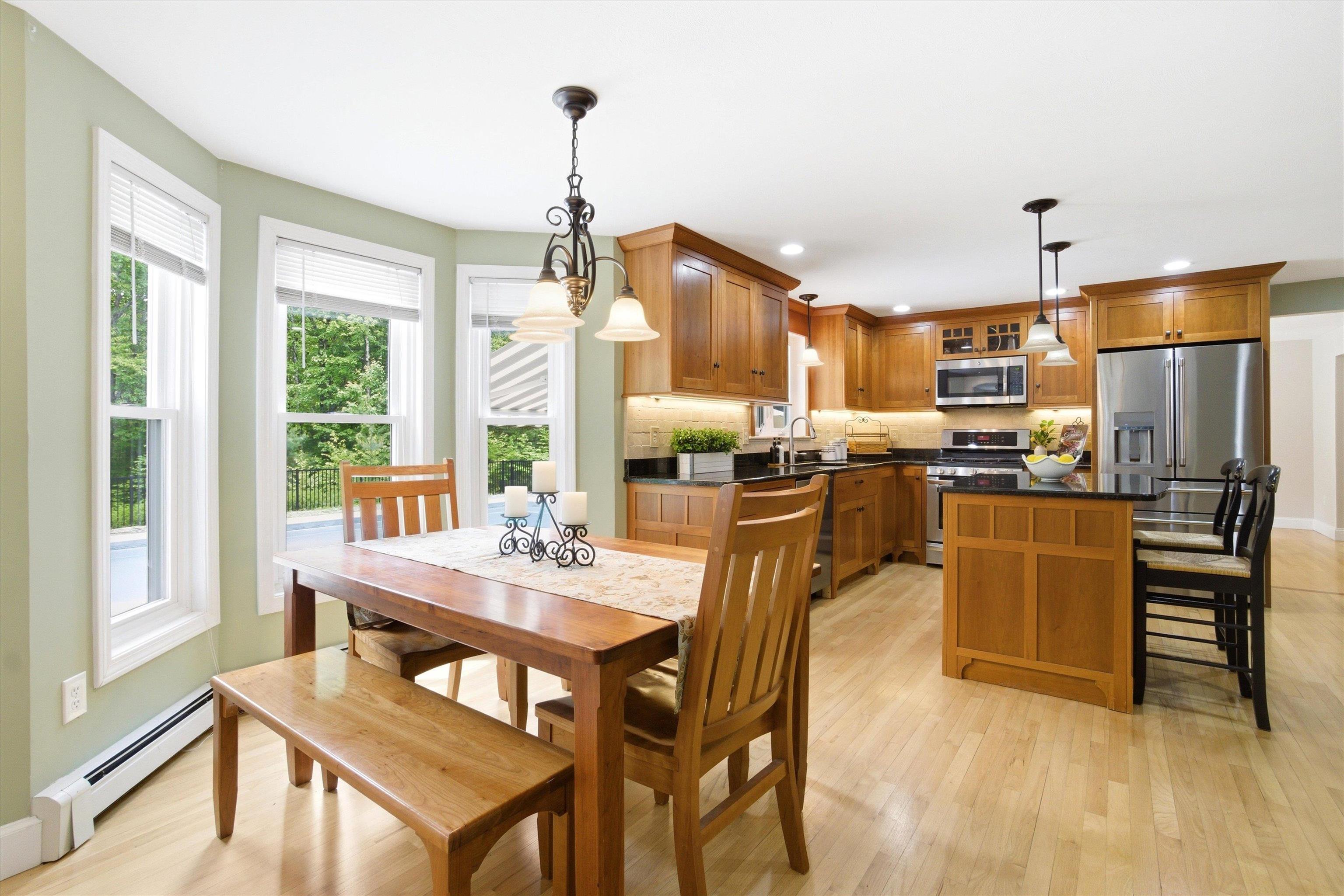 Sunny breakfast nook with bay windows overlooking the backyard.