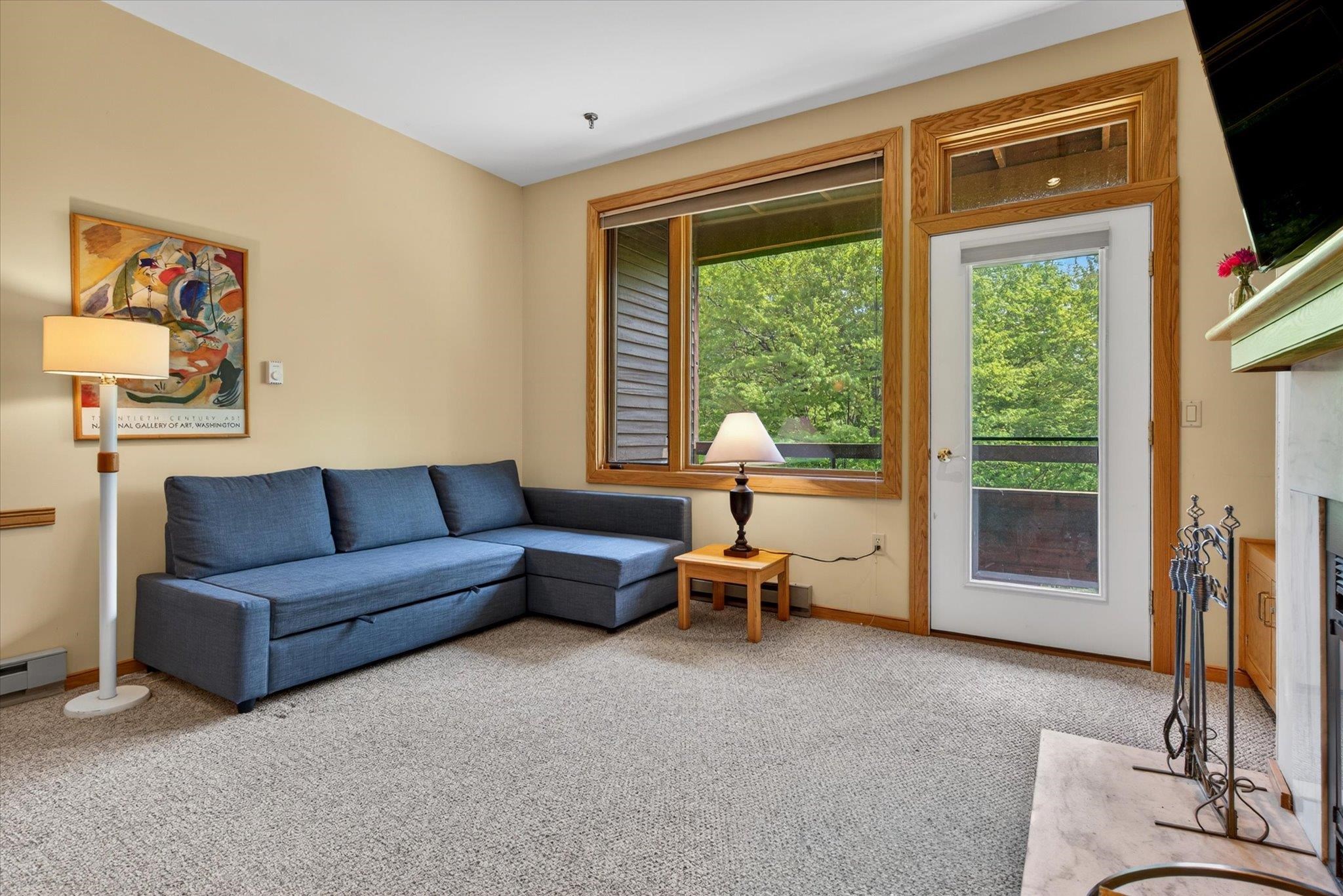 Bright and airy living space with door to private balcony