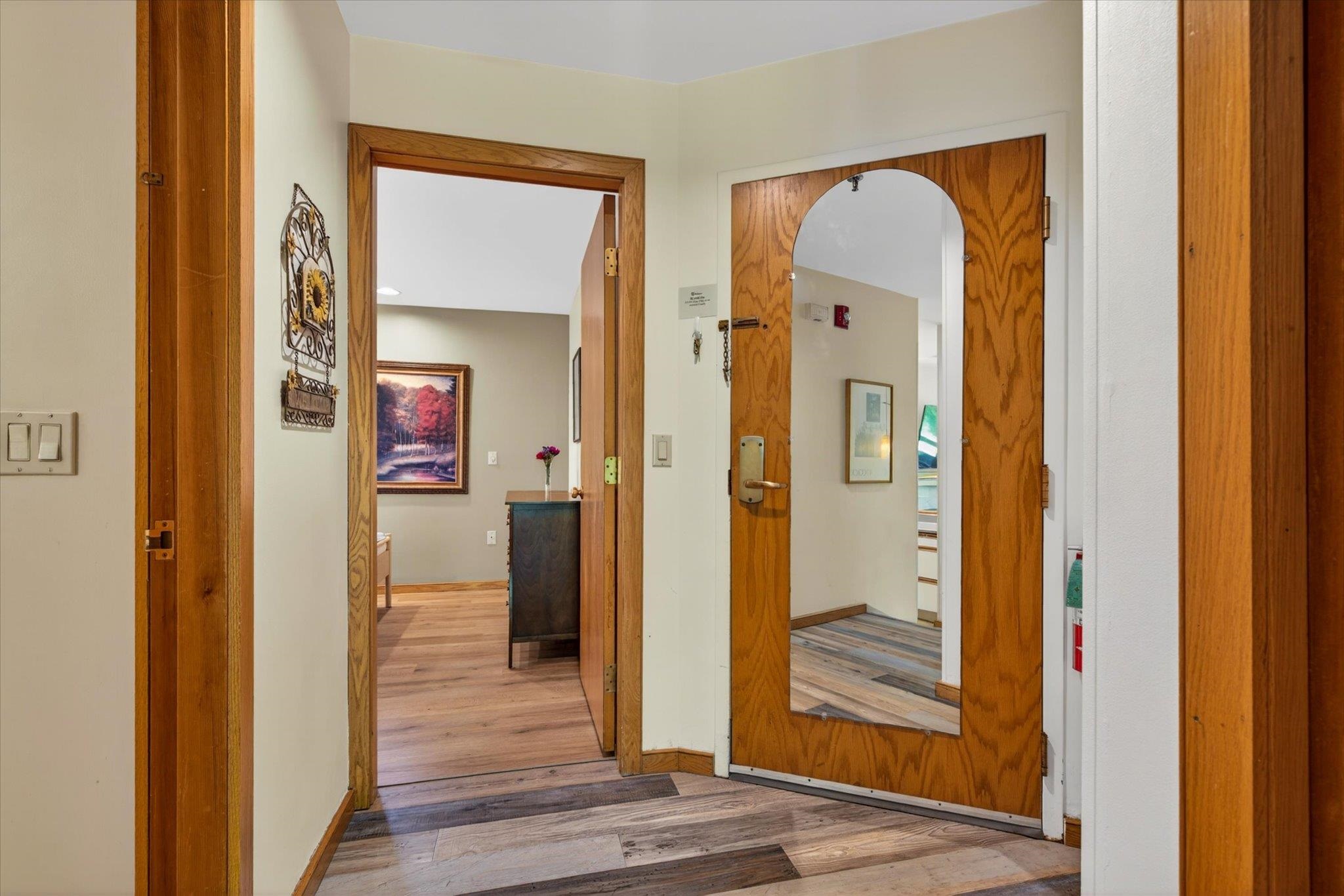 Entry door on right side, bedroom door to left