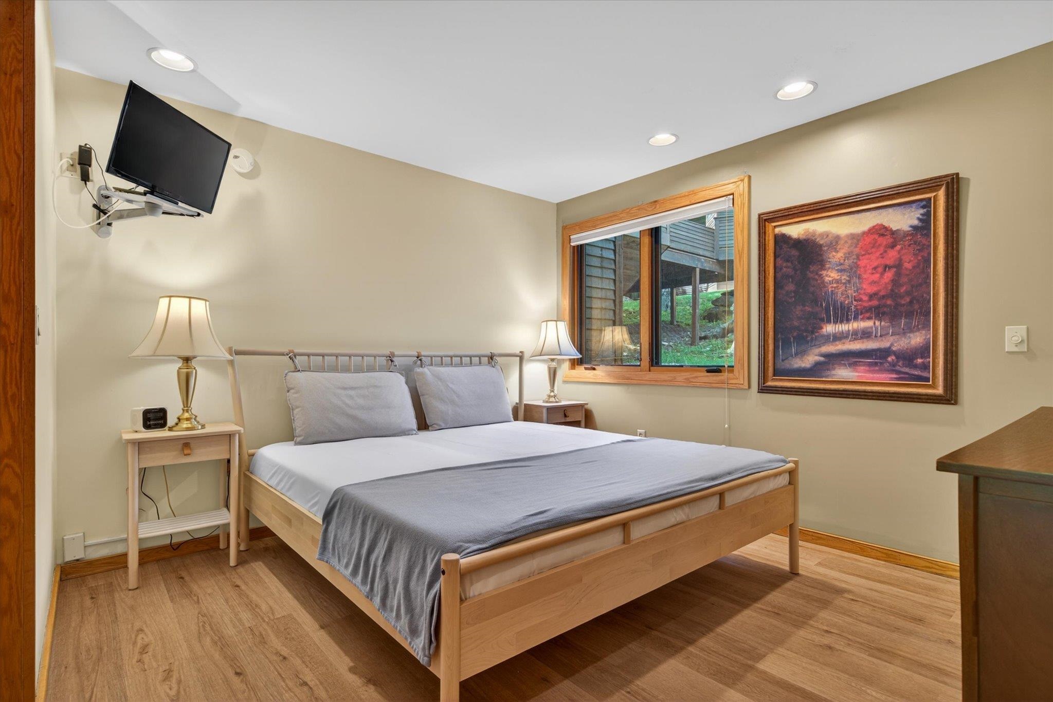 Large bedroom with updated flooring and furniture