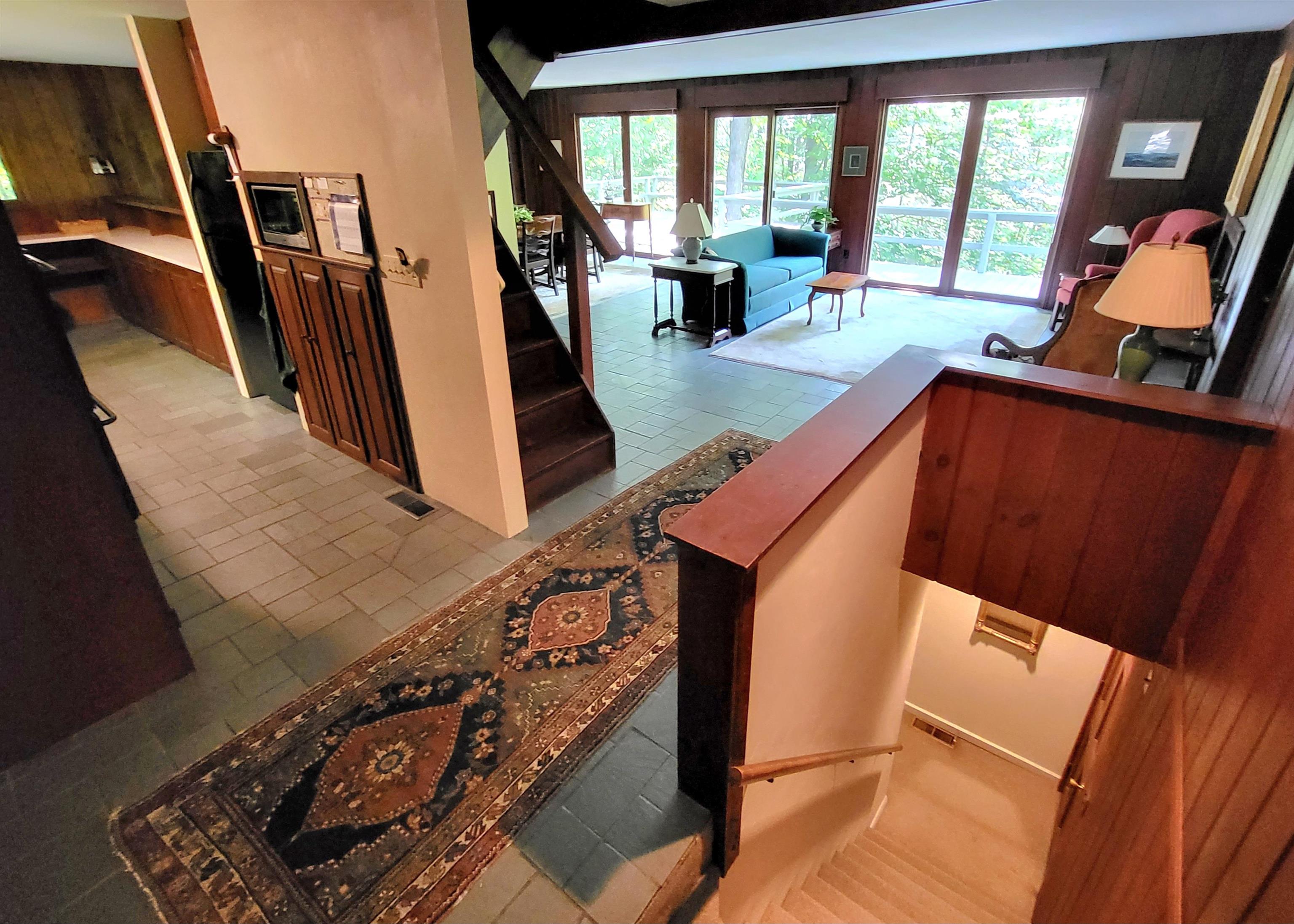 View from top on lower level stairs looking towards kitching dining living 25863884
